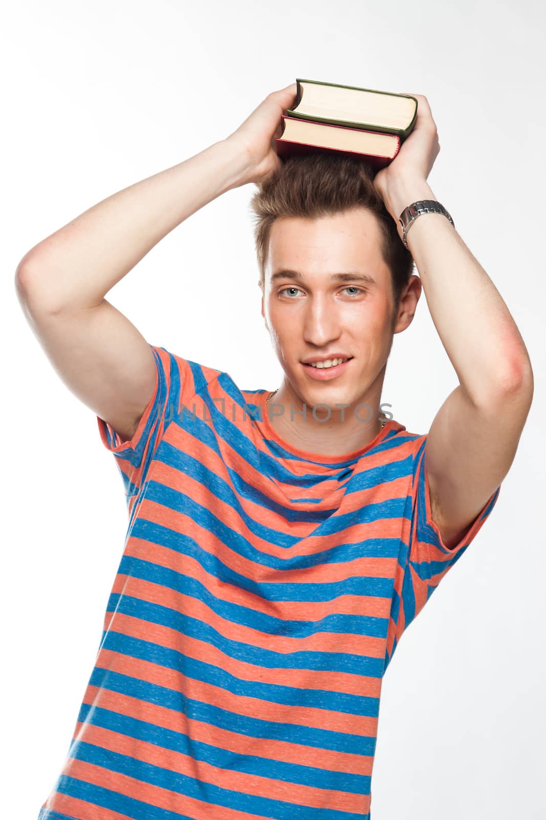Portrait of a young attractive guy who is preparing for the exams at a university or college