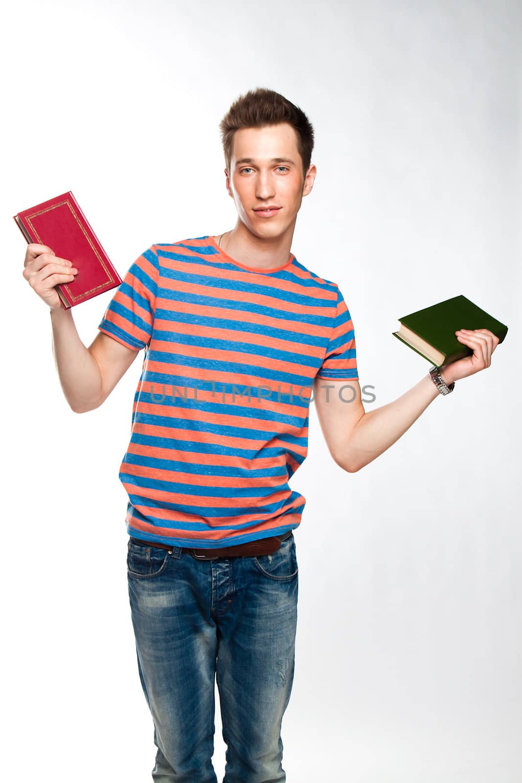 Portrait of a young attractive guy who is preparing for the exams at a university or college