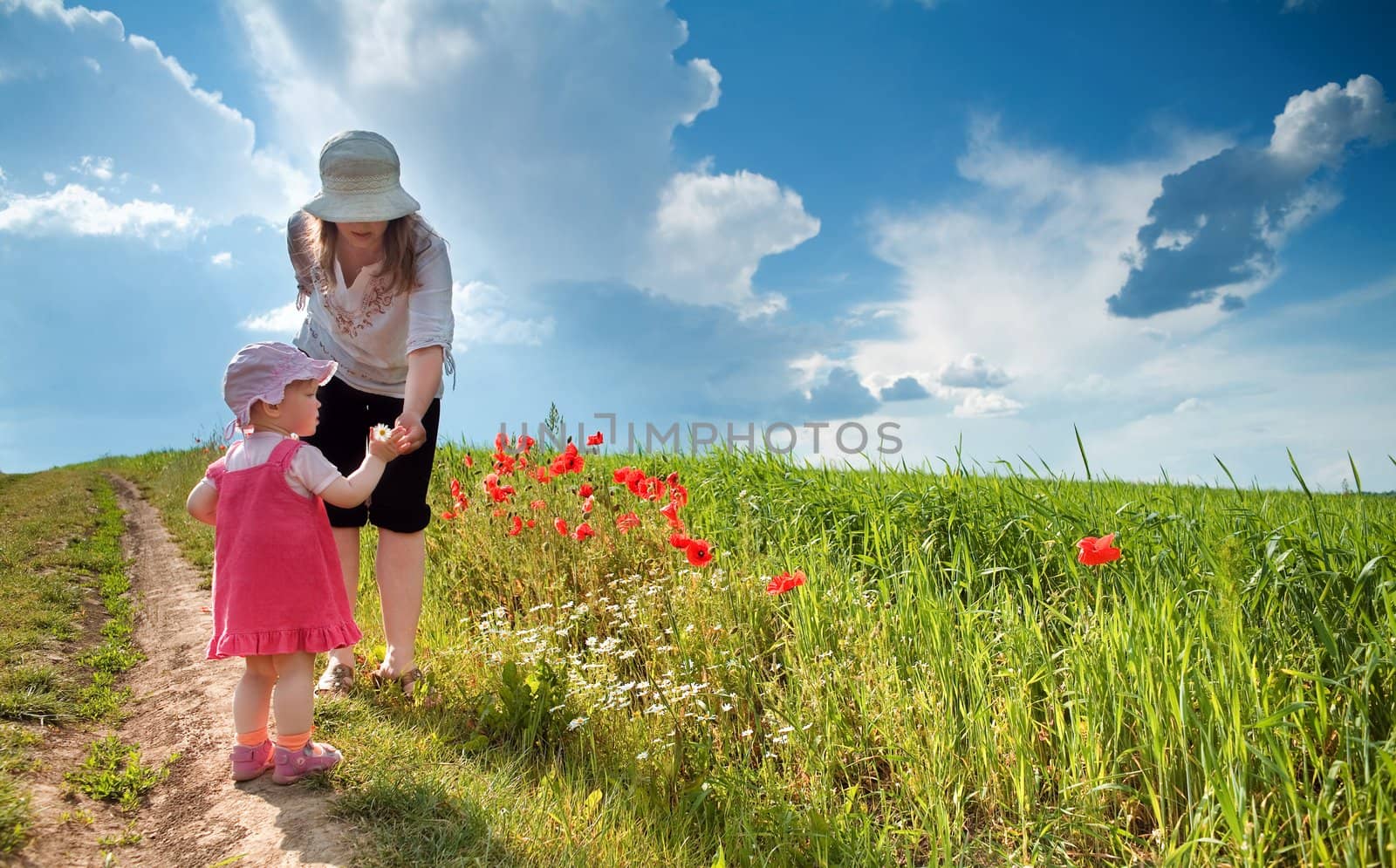Ma with daughter amongst poppy-field