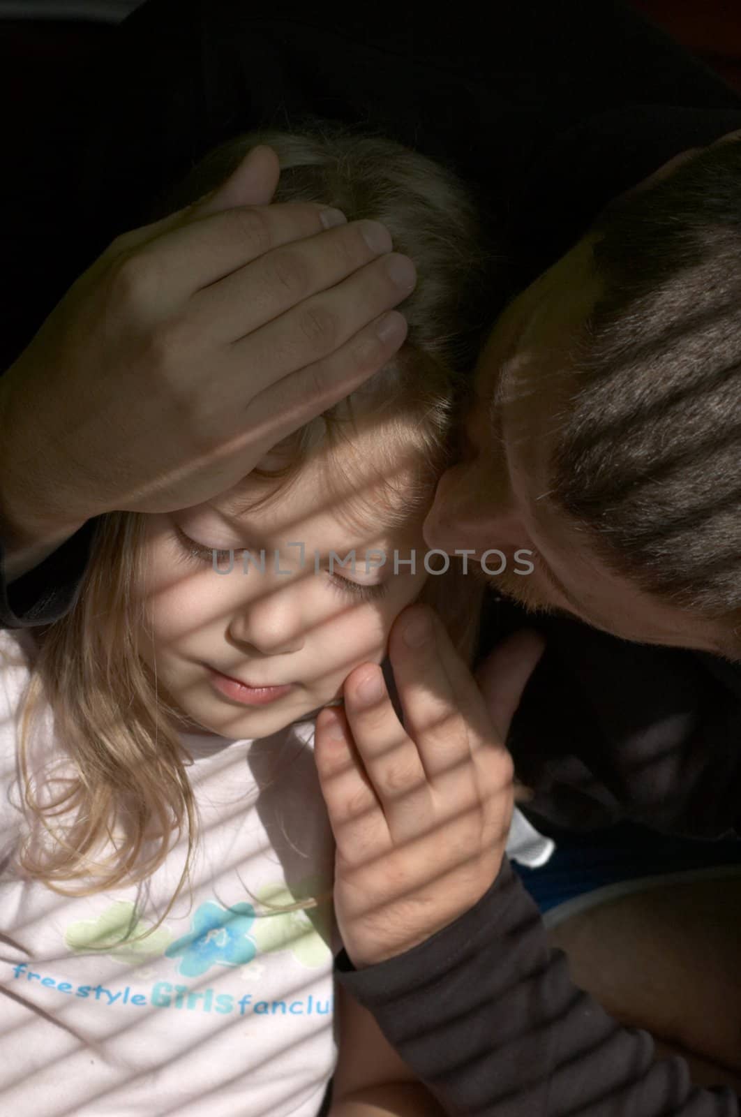 An image of father kissing his daughter