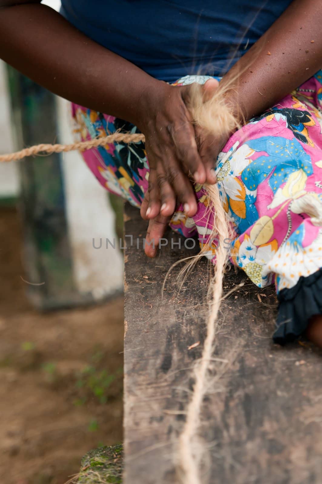 Female hands make a corn from copra fibre as a traditional twines and corns production in Asia
