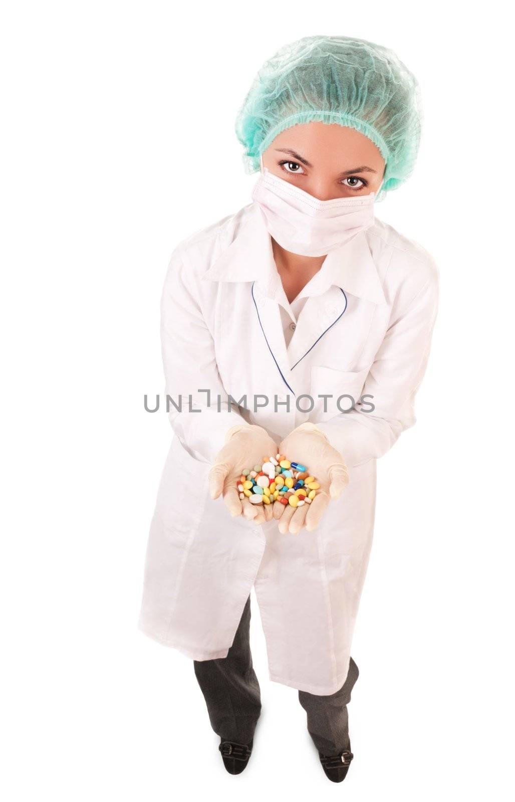 Serious doctor with pills in hands isolated on white background