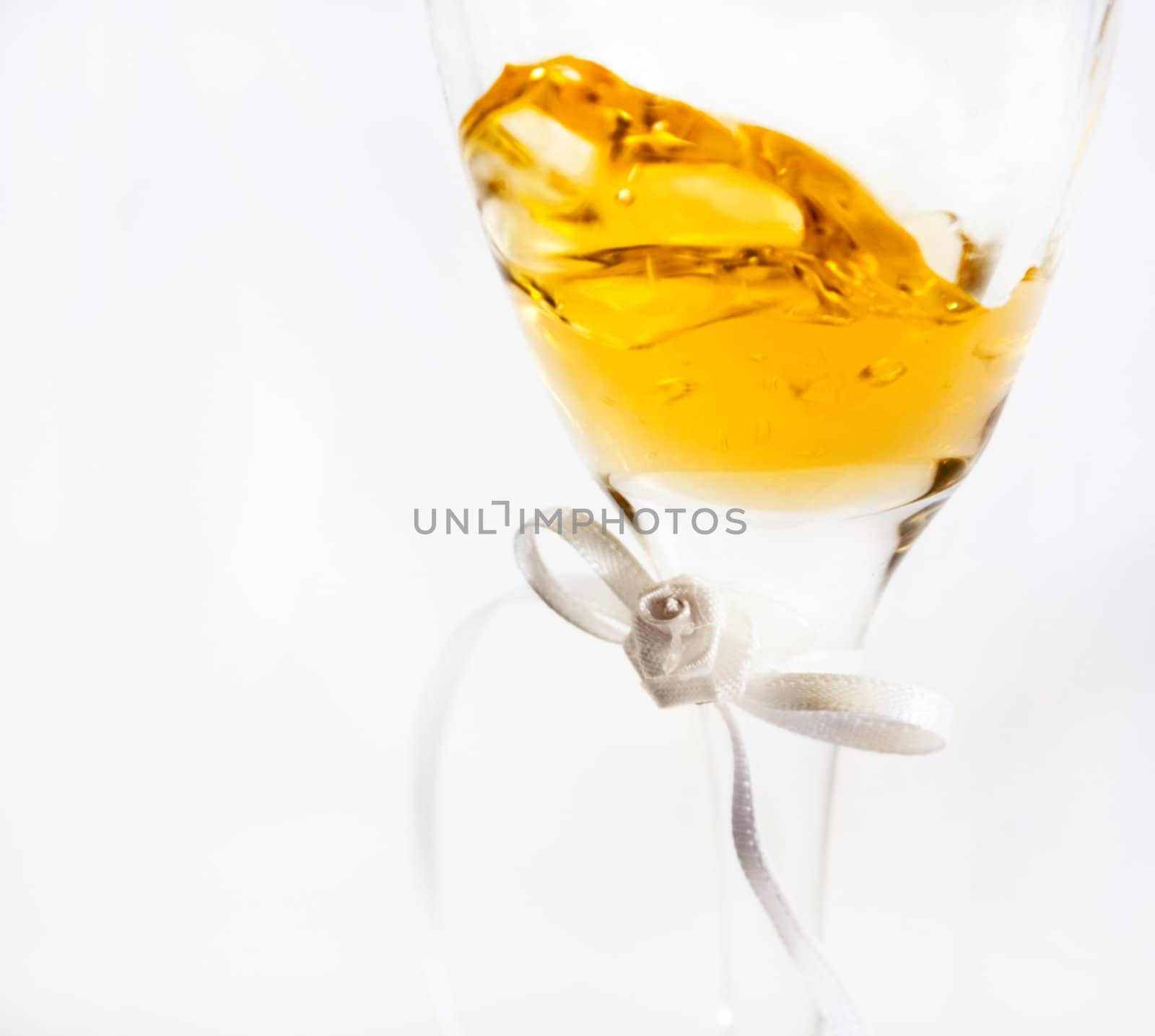 Wine inside a glass showing slight movement, image fades into and is isolated against a white background