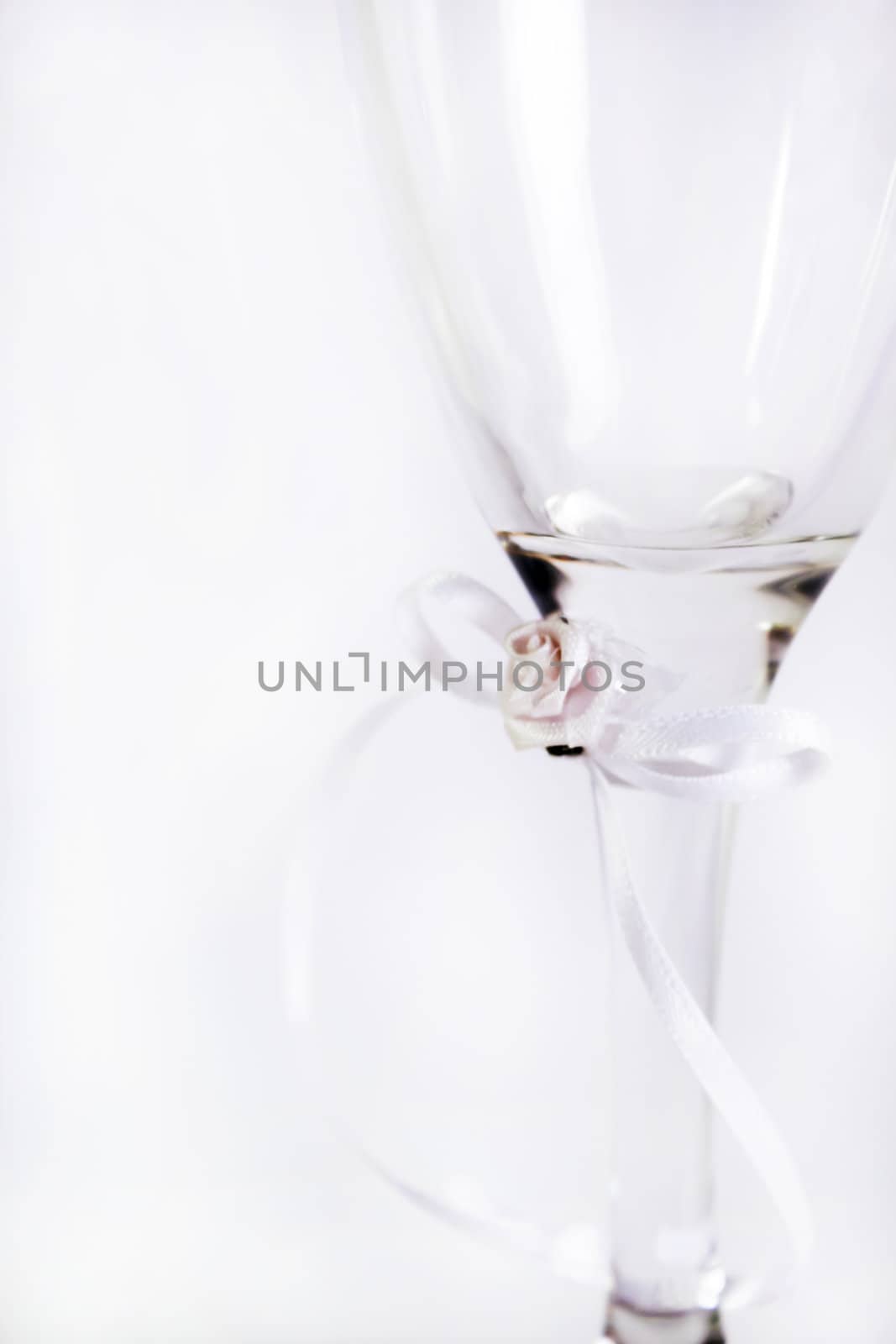 wedding glass isolated against a background. glass does have a ribbon bow tied around it