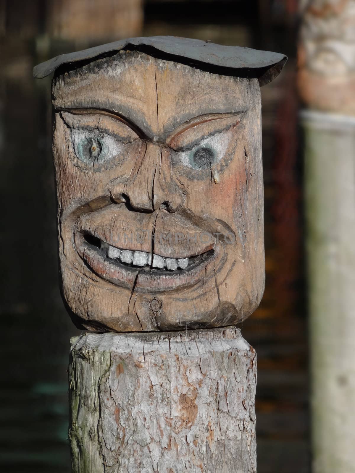 A carved face sculpture on pier