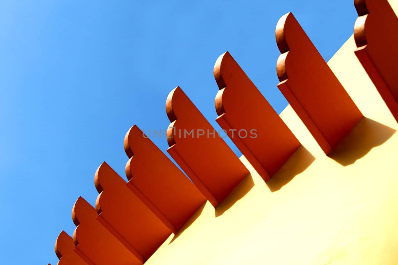 Wooden exterior wall decor against the clear blue sky