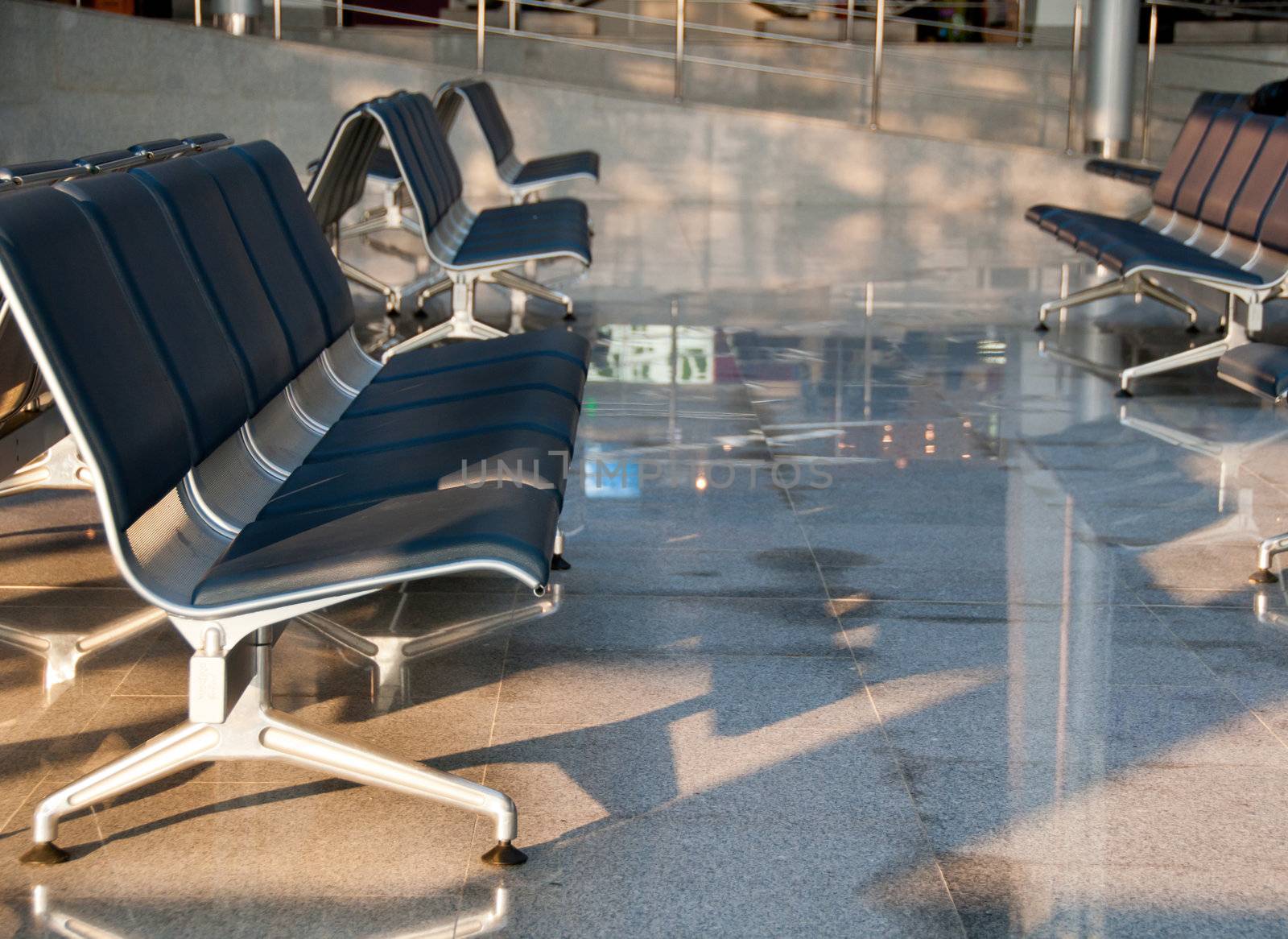 Rows of empty sits in airport. Focus on the front.