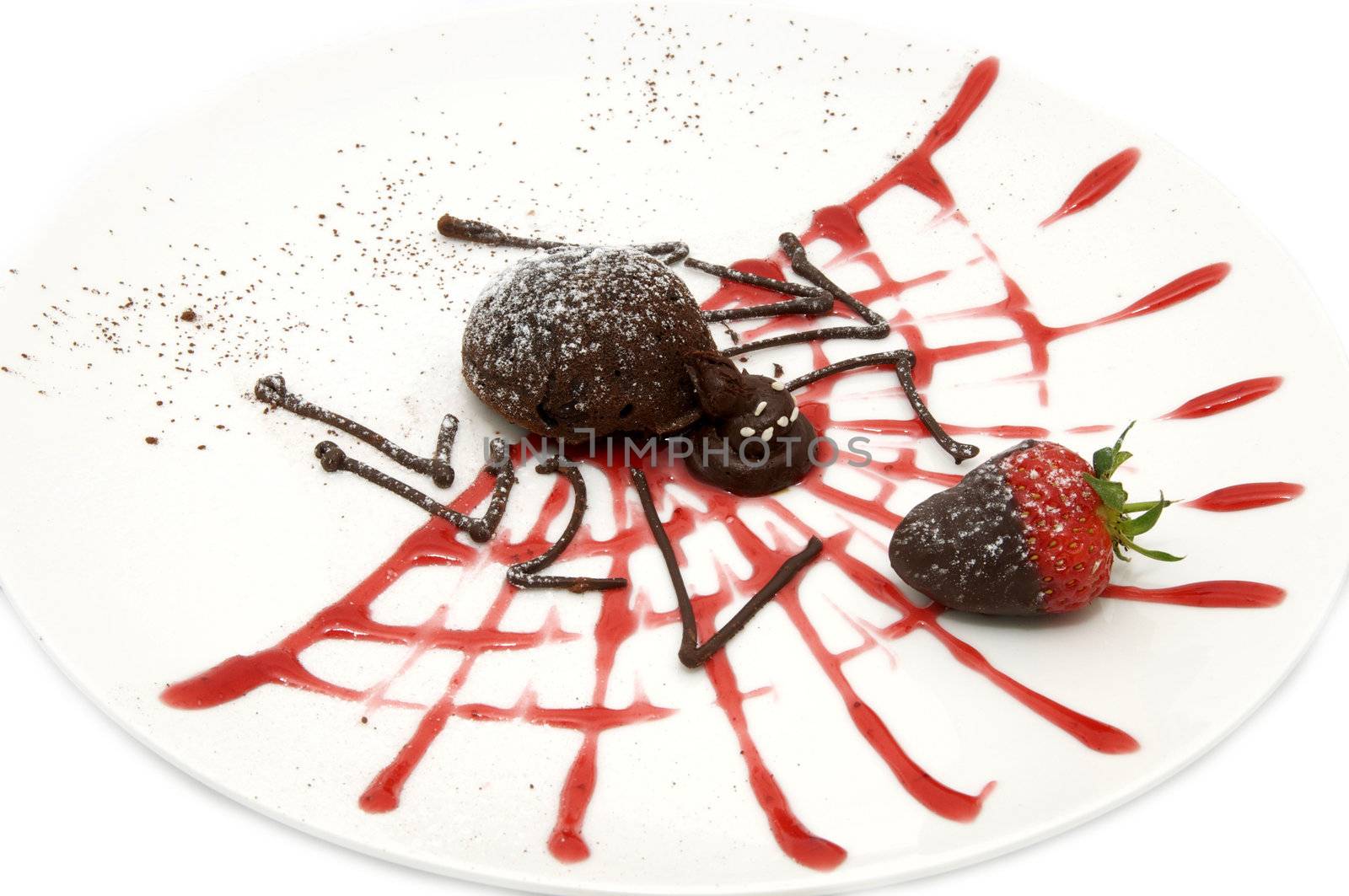 Strawberries and chocolate dessert in the form of a spider on a white background