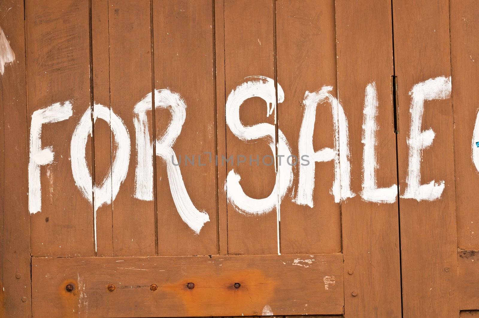 Simple advertising by paint on wooden wall