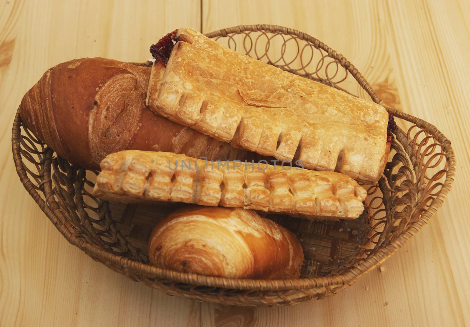 Bread and pastries in braided basket on table