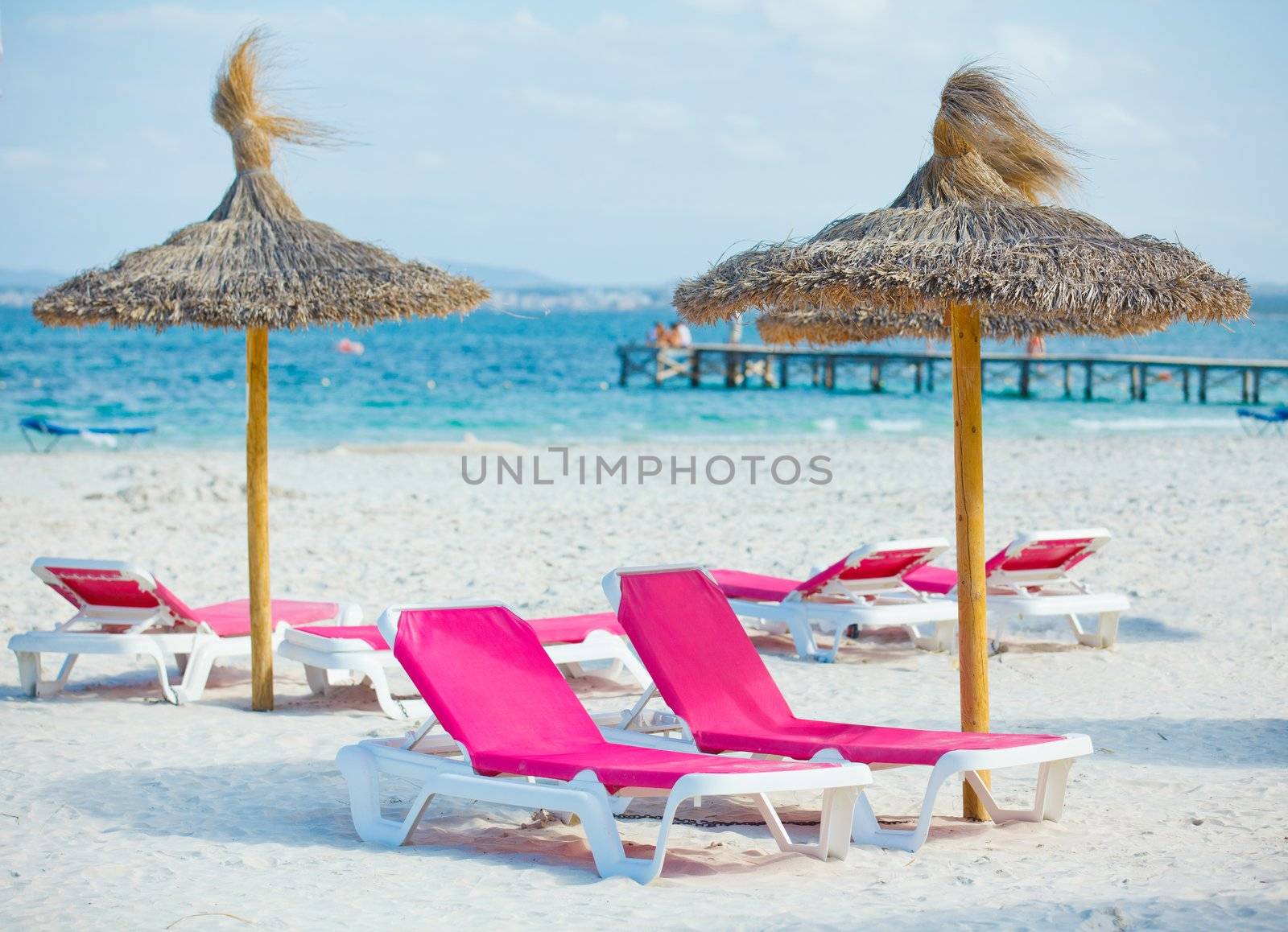 view of two chairs and umbrella on the beach