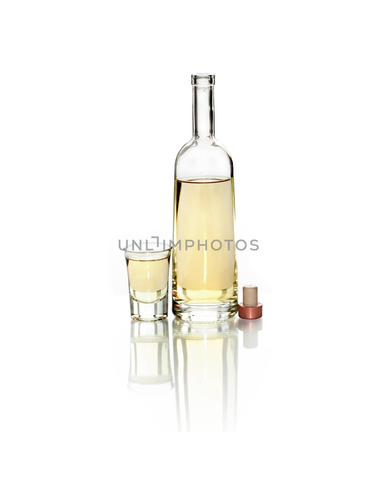 Open bottle of wine near full wineglass on white background. Clipping path is included