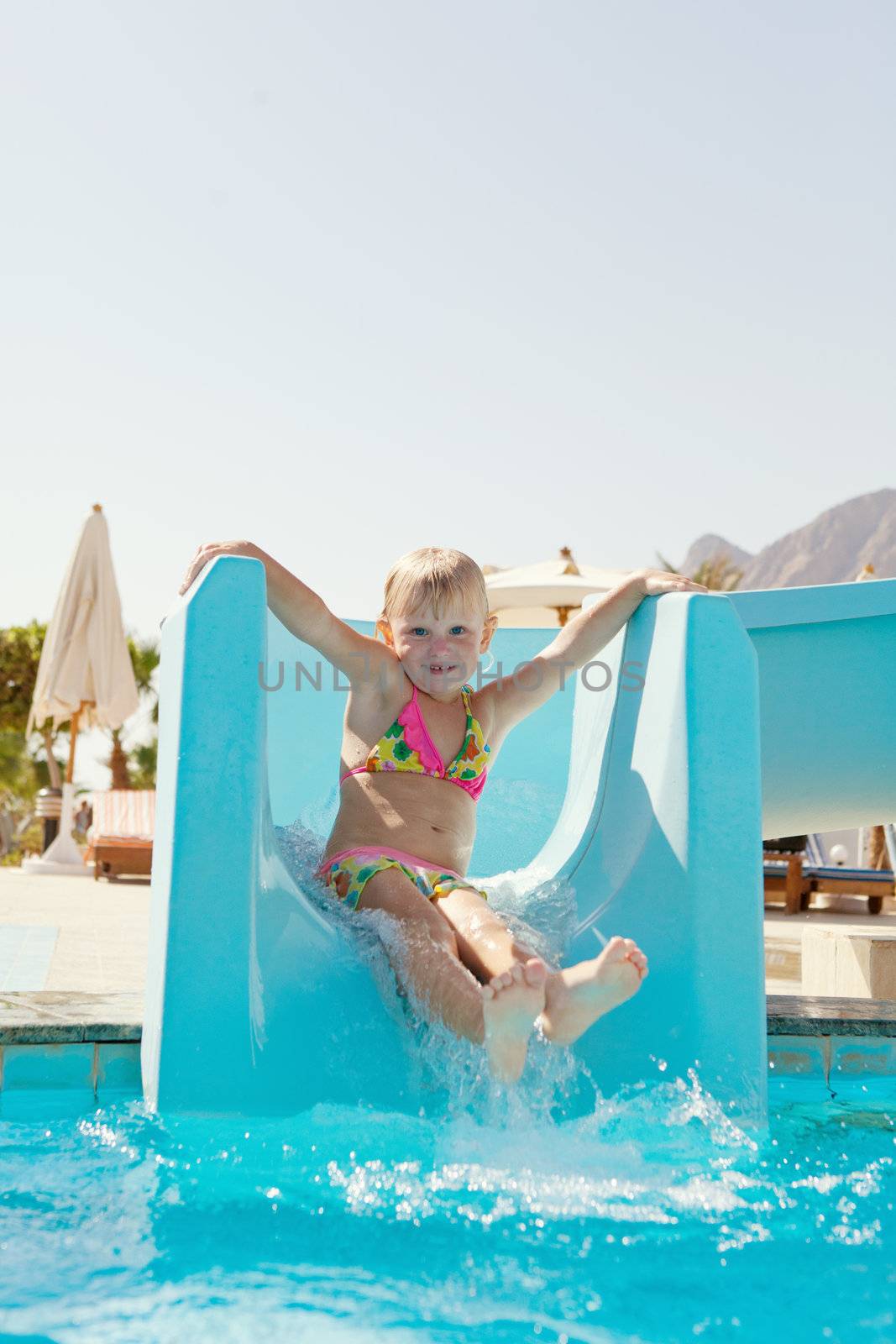 pretty happy little girl on slide