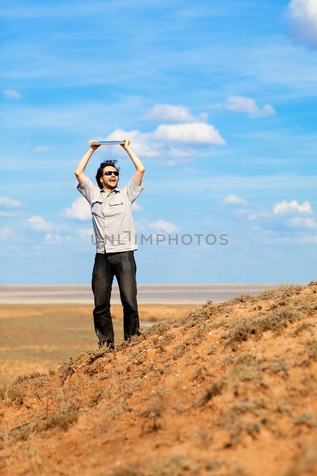 young man with laptop outdoors