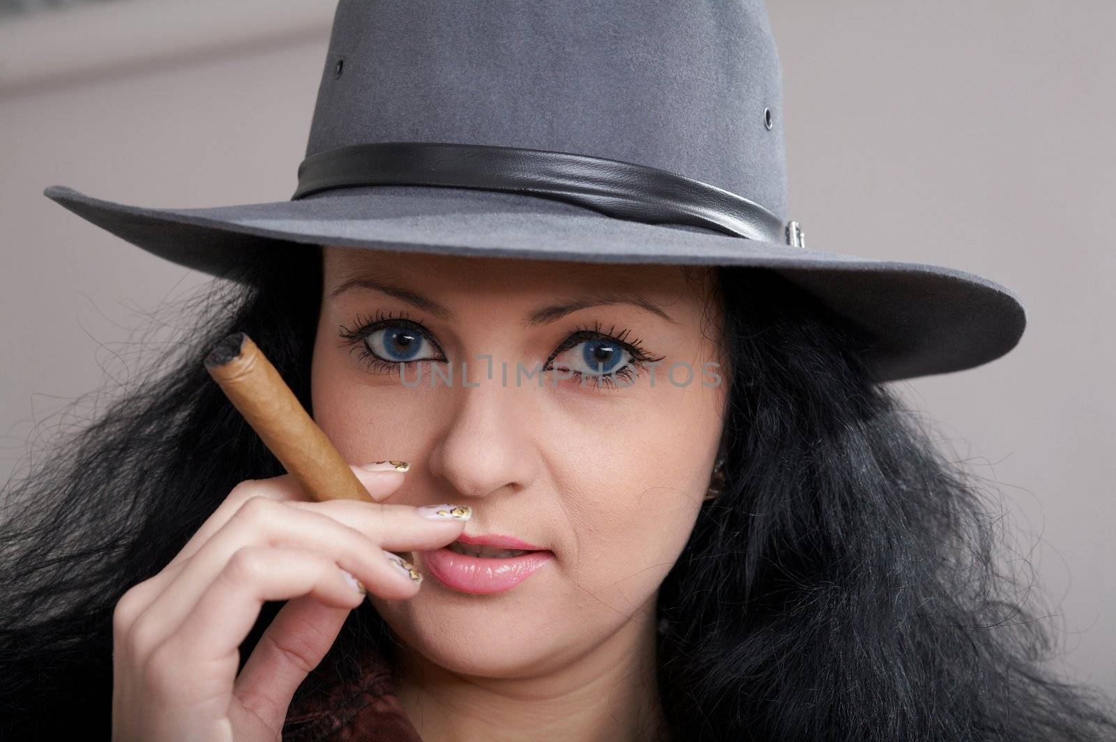 An image of a nice woman in felt hat with cigar