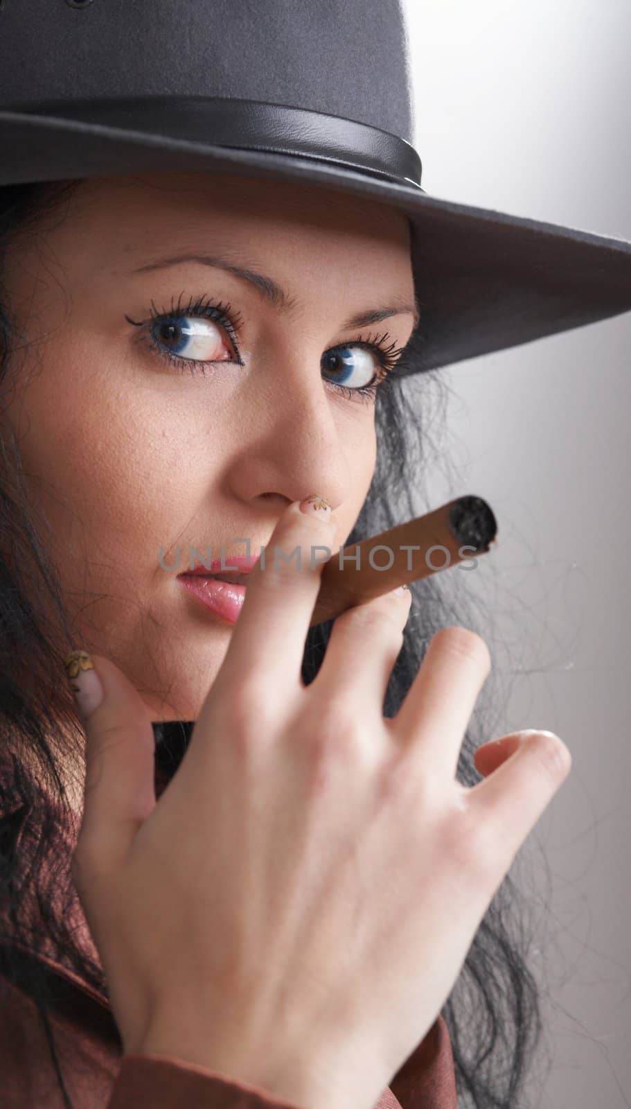 An image of a nice woman in felt hat smoking cigar