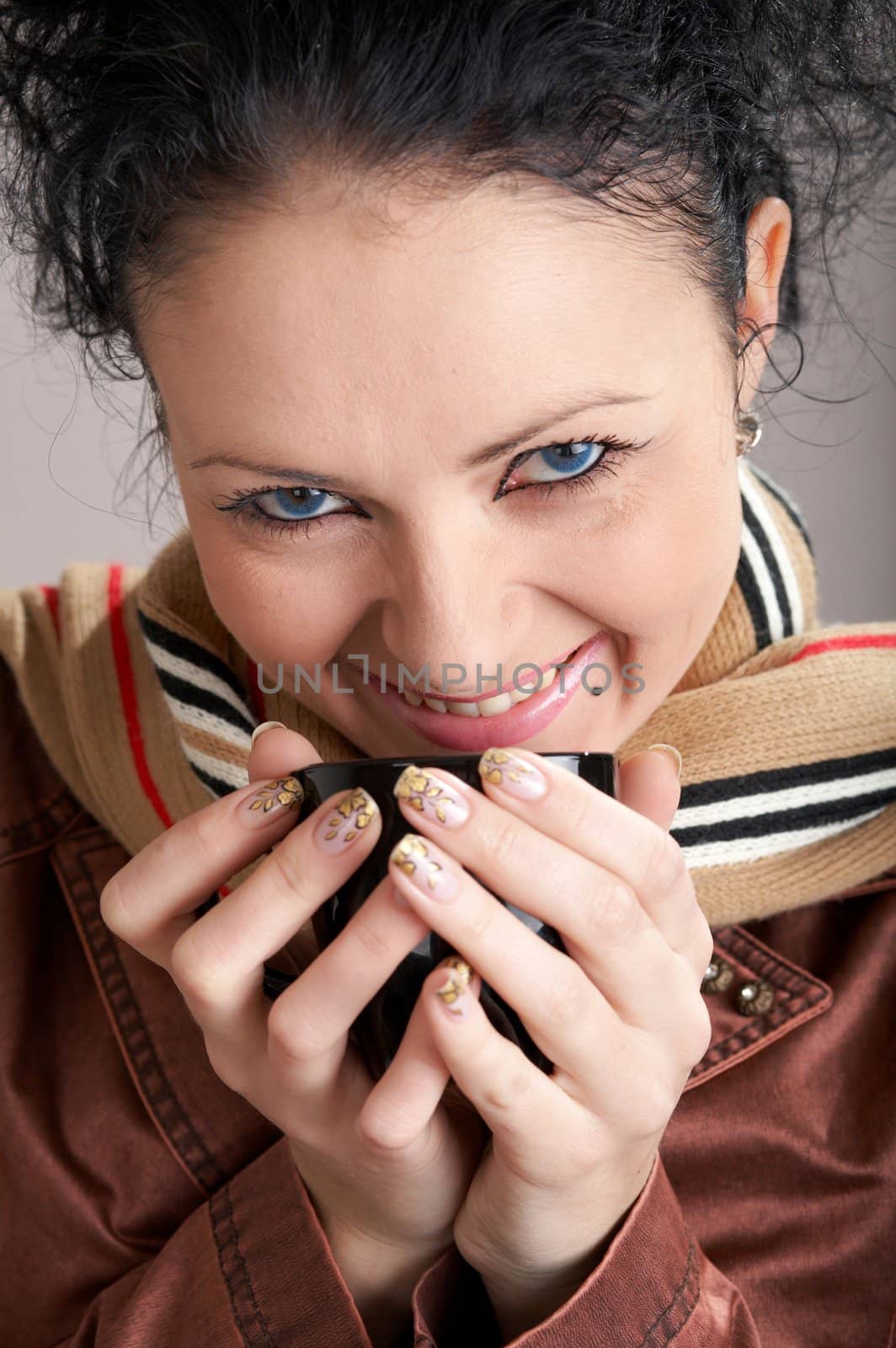 An image of smiling girl drinking tea