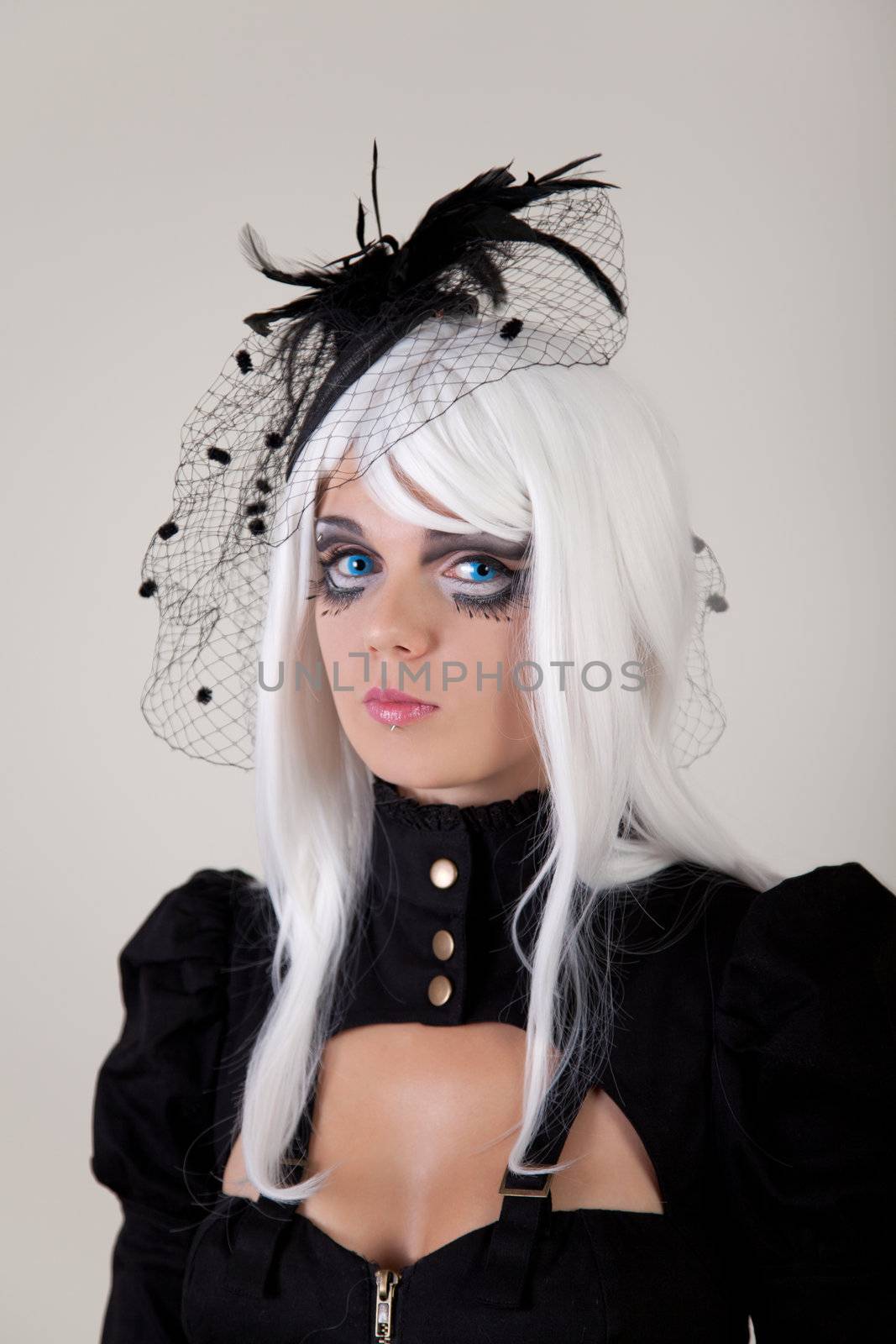 Fantasy girl with creative make-up and blue contact lenses, studio shot 