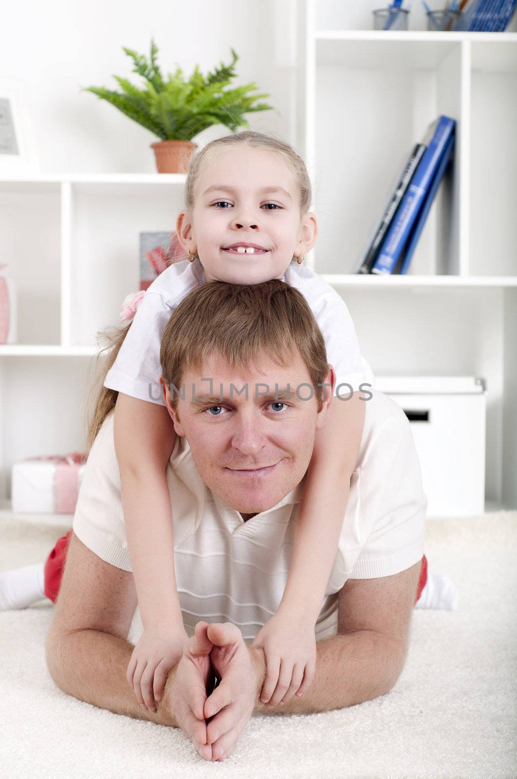 Portrait of happy family lying together, hugging and happy