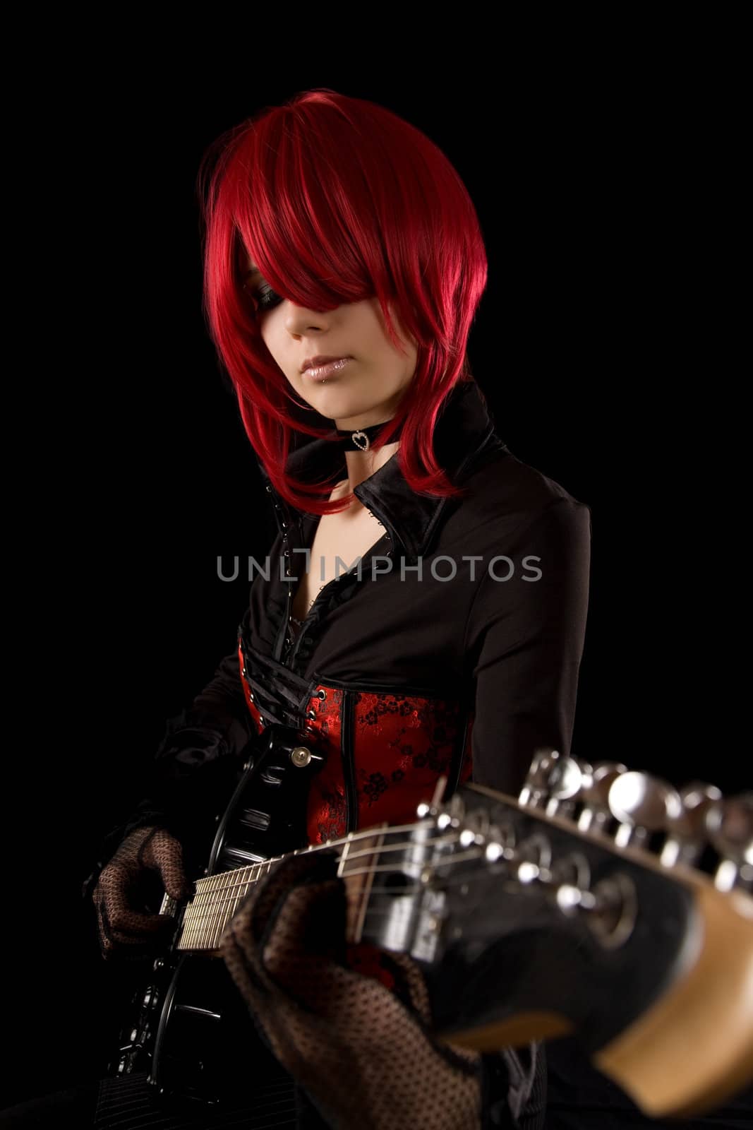 Attractive girl playing guitar, isolated on black background    