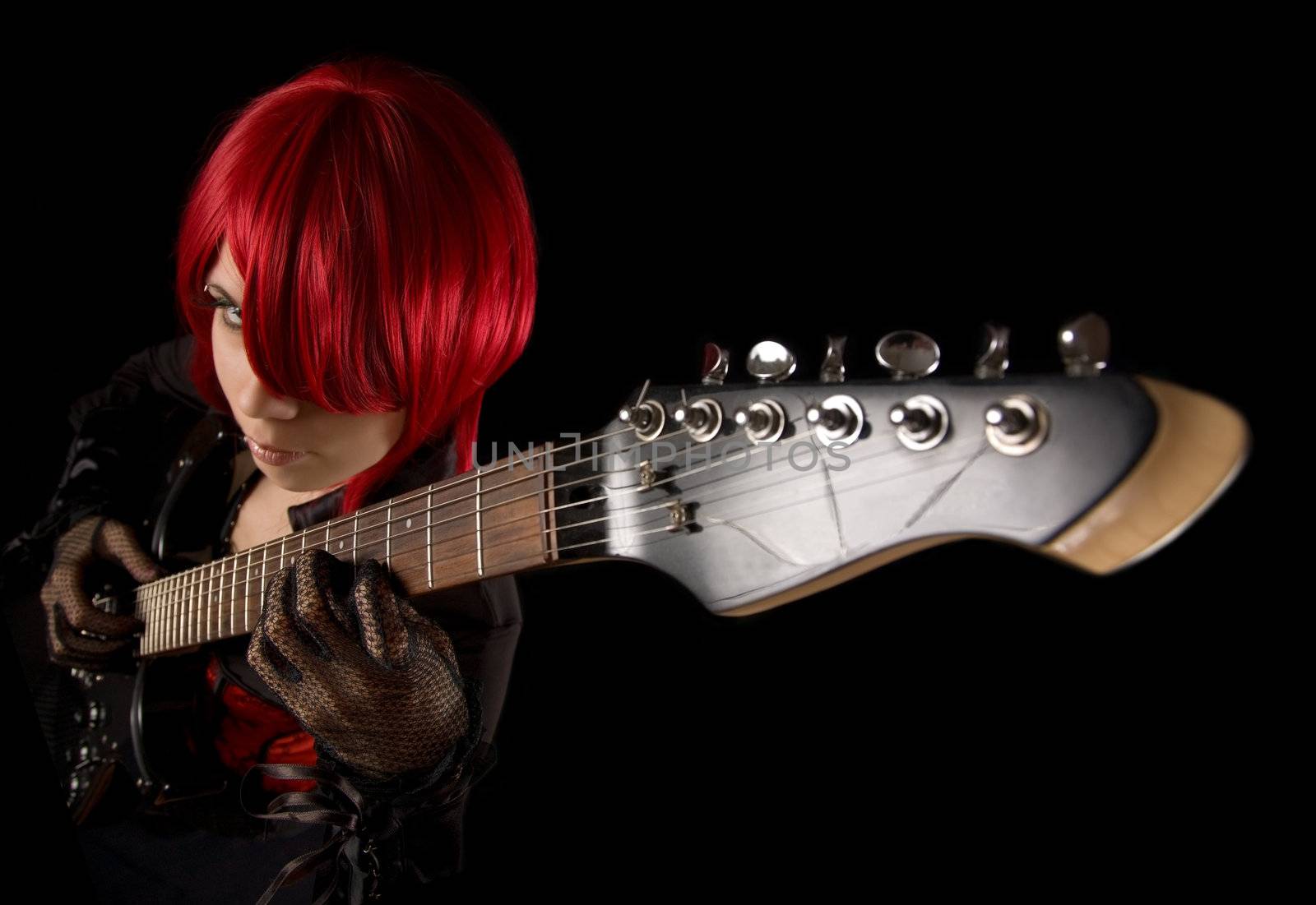 Attractive girl with guitar, selective focus on fingers, high angle view 