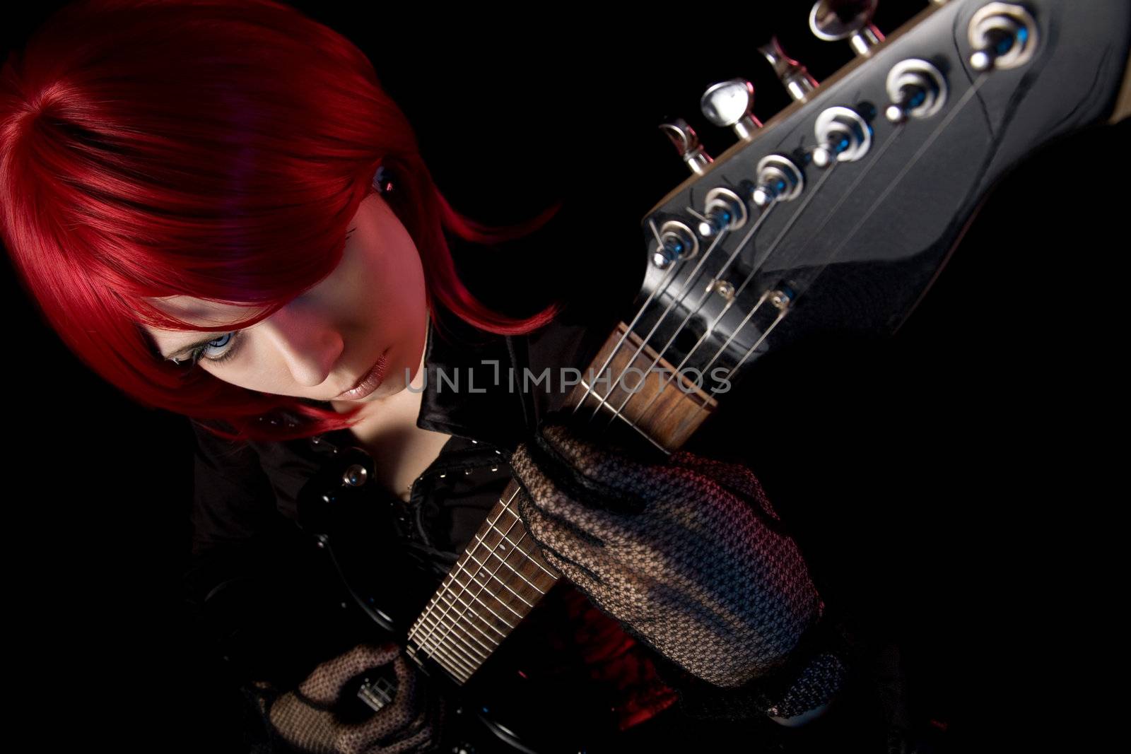 Redhead girl with guitar, selective focus on face, high angle view 