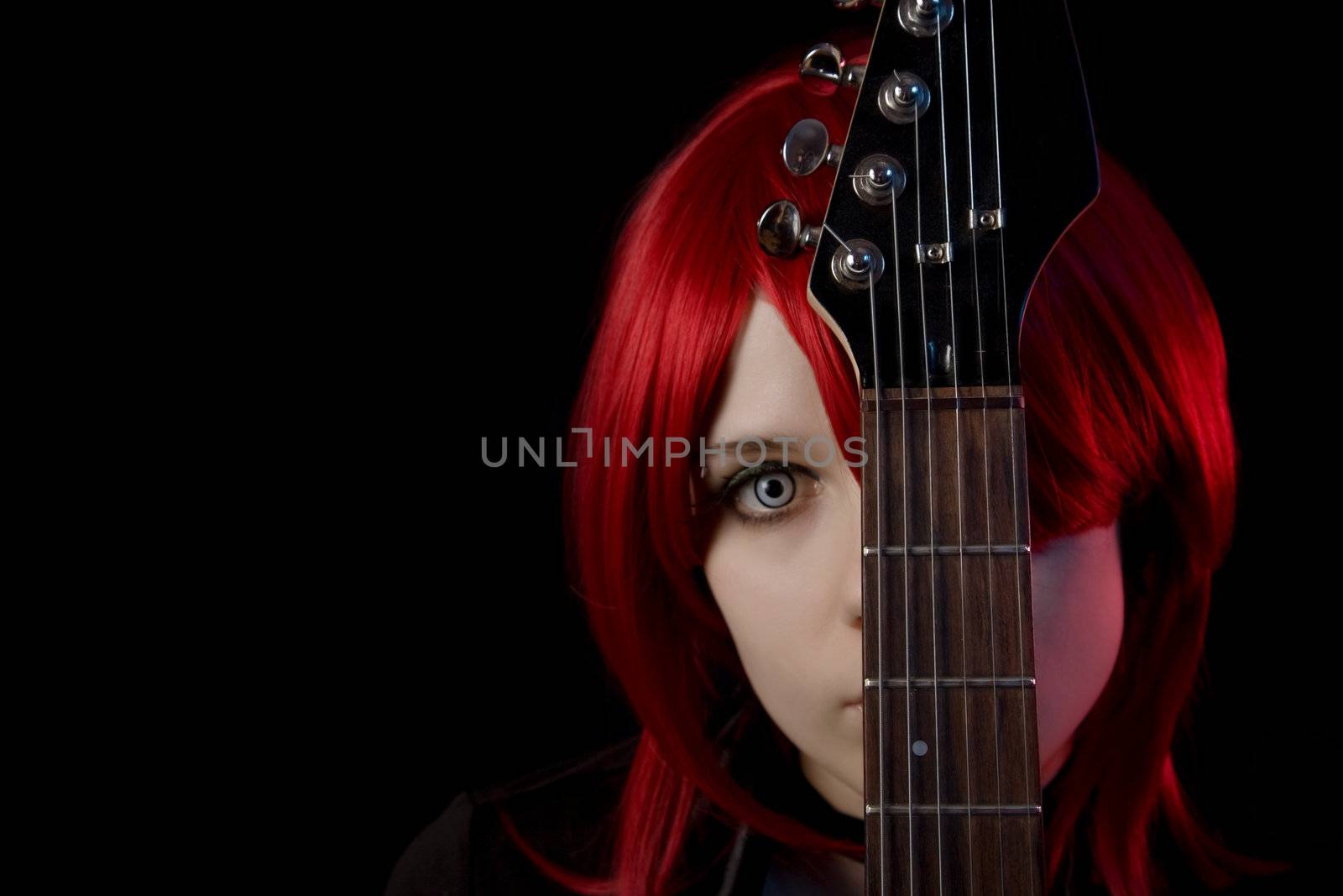 Gothic girl wearing scary lenses with guitar, selective focus on guitar, copyspace for your text  
