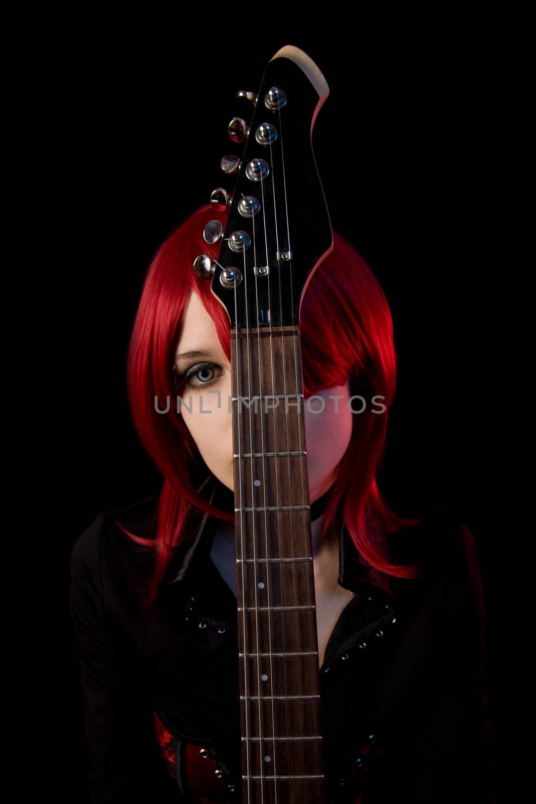 Gothic girl with guitar, selective focus on guitar, isolated on black background 