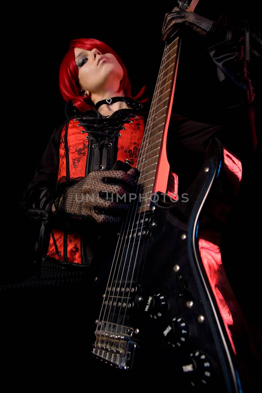 Sexy girl playing guitar, focus on guitar, low angle view  