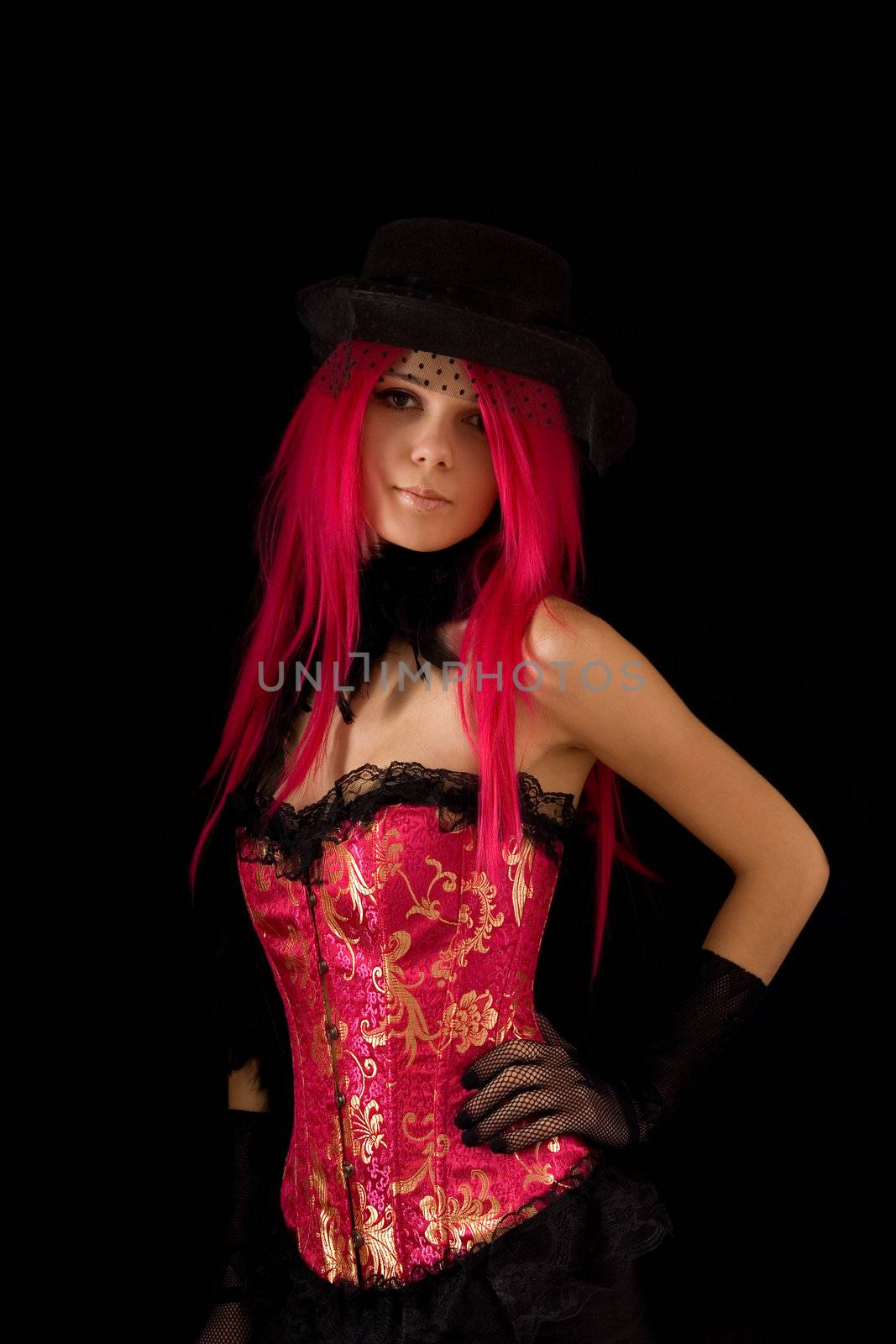 Cabaret girl in pink corset and hat with veil, isolated on black background 