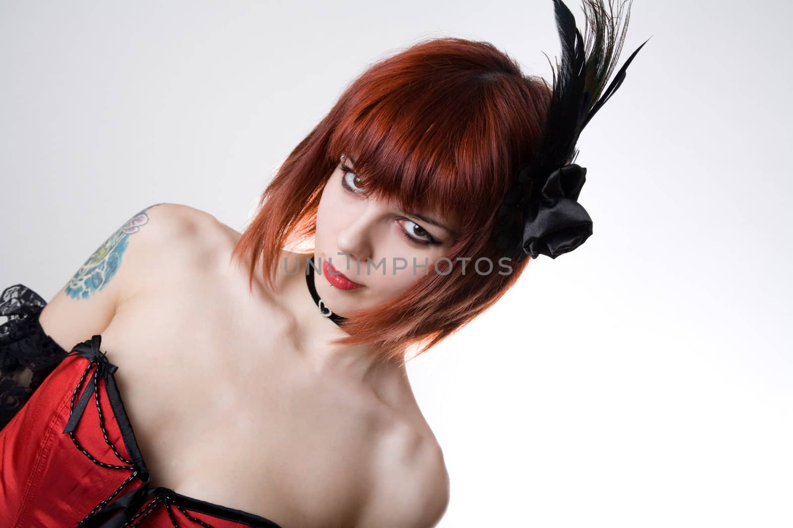 Cabaret girl with hair fascinator, studio shot on white background 