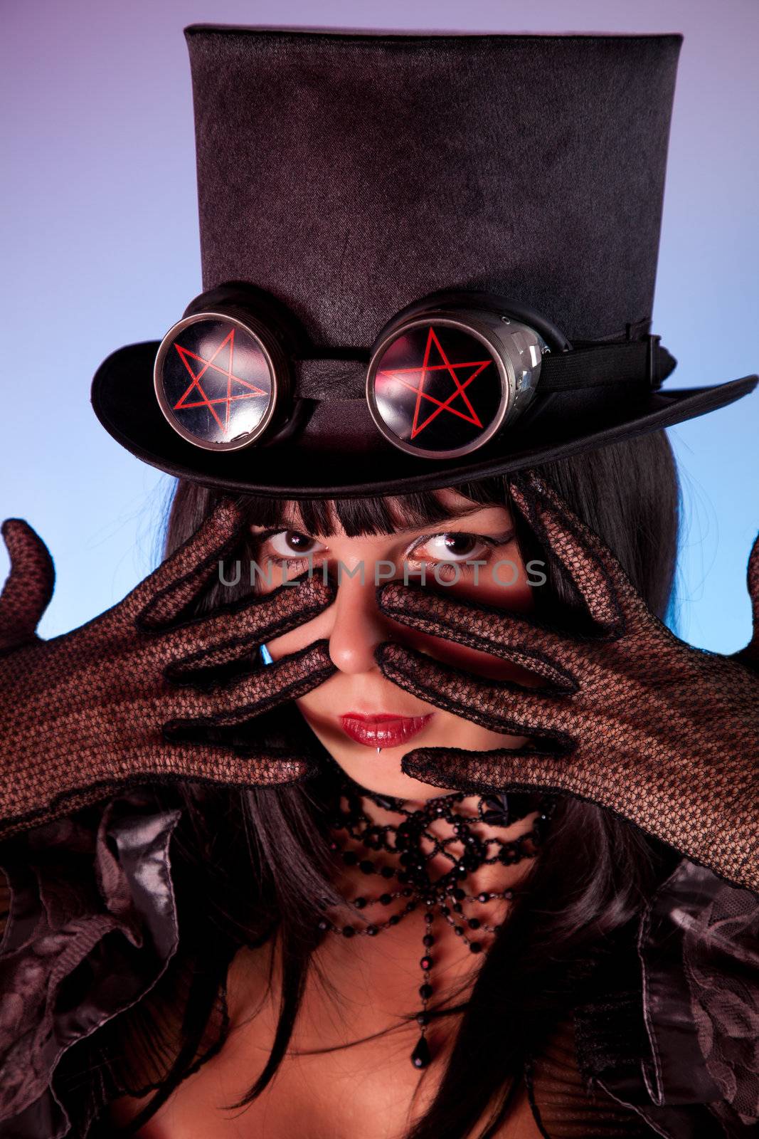 Portrait of gothic girl wearing tophat with pentacles, Halloween theme 