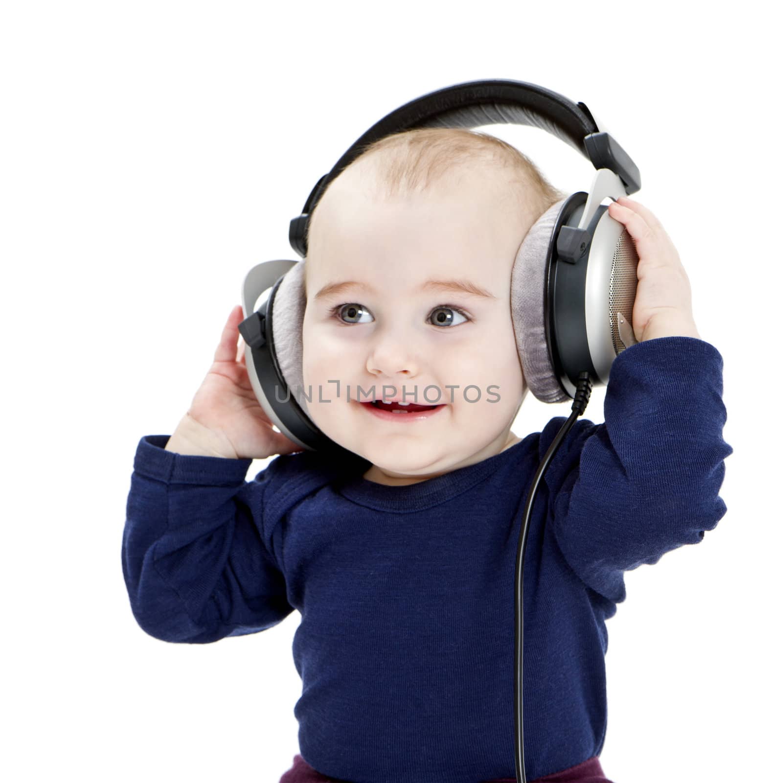 young child with earphones listening to music. isolated on white background
