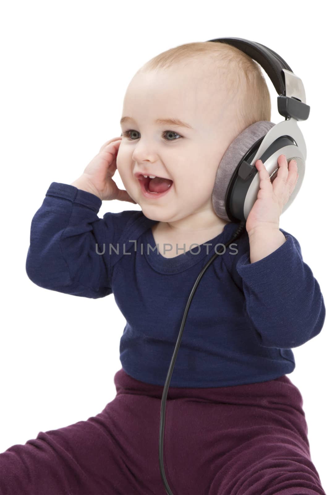 young laughing child with earphones listening to music. isolated on white background