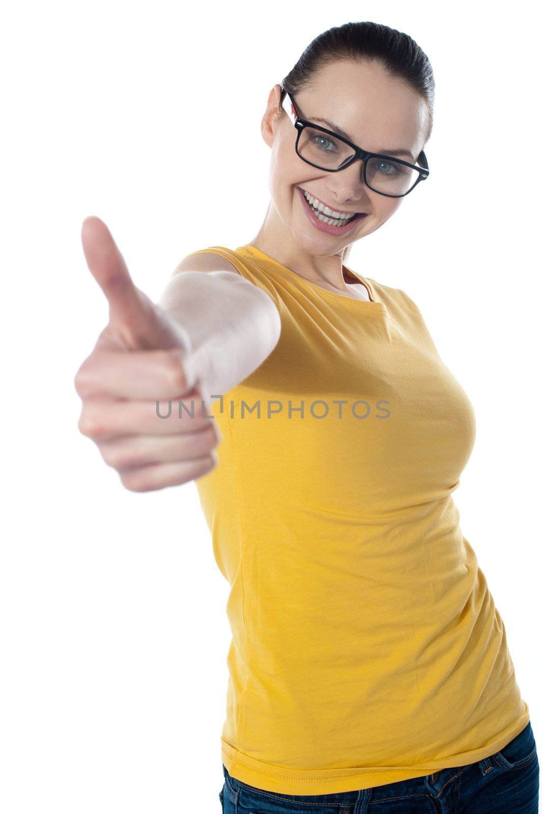 Pretty teenager showing thumbs-up wearing glasses