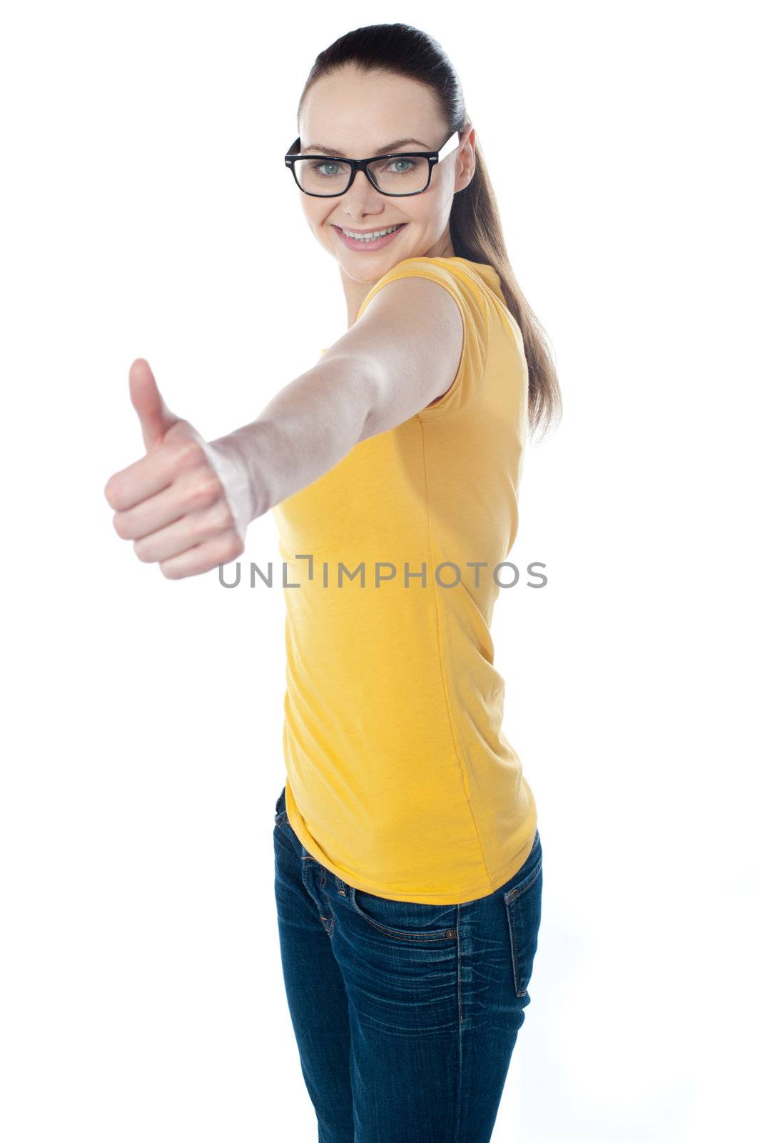 Glamourous teenager gesturing thumbs-up isolated on white