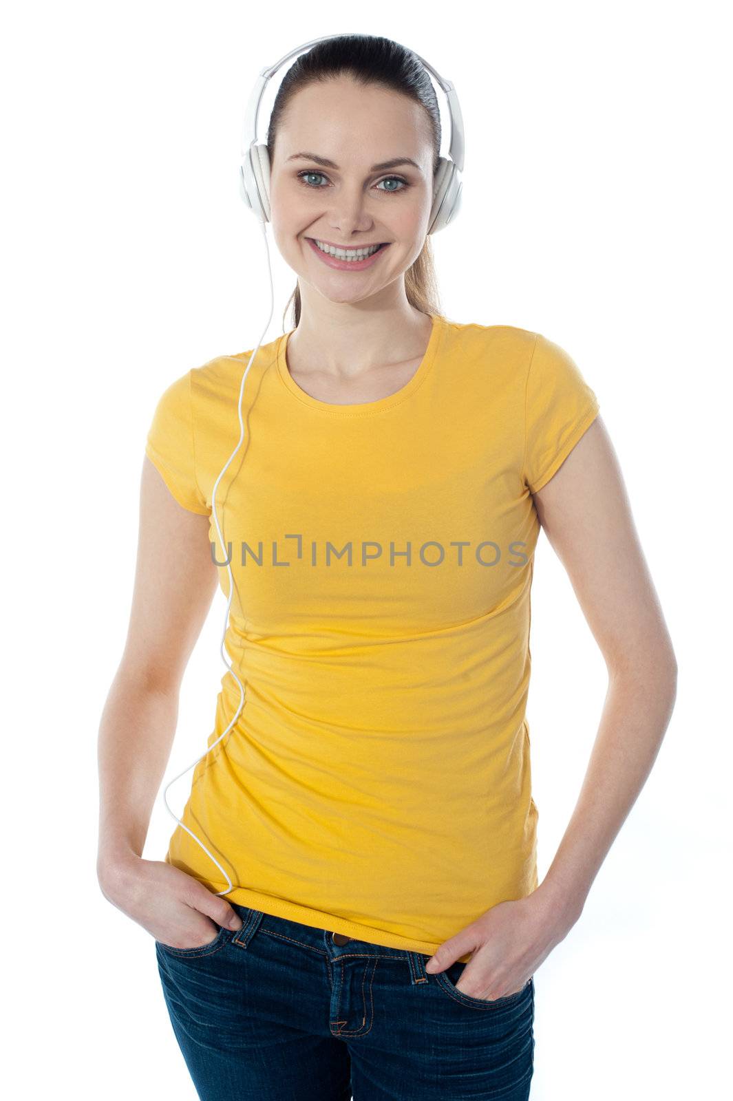 Beautiful woman listening music with headphones by stockyimages