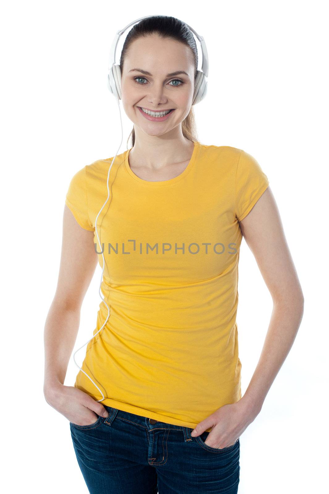 Beautiful woman listening music with headphones, posing in style