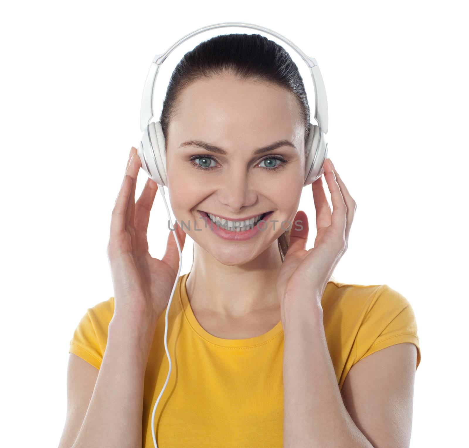 Pretty young female enjoying music by stockyimages