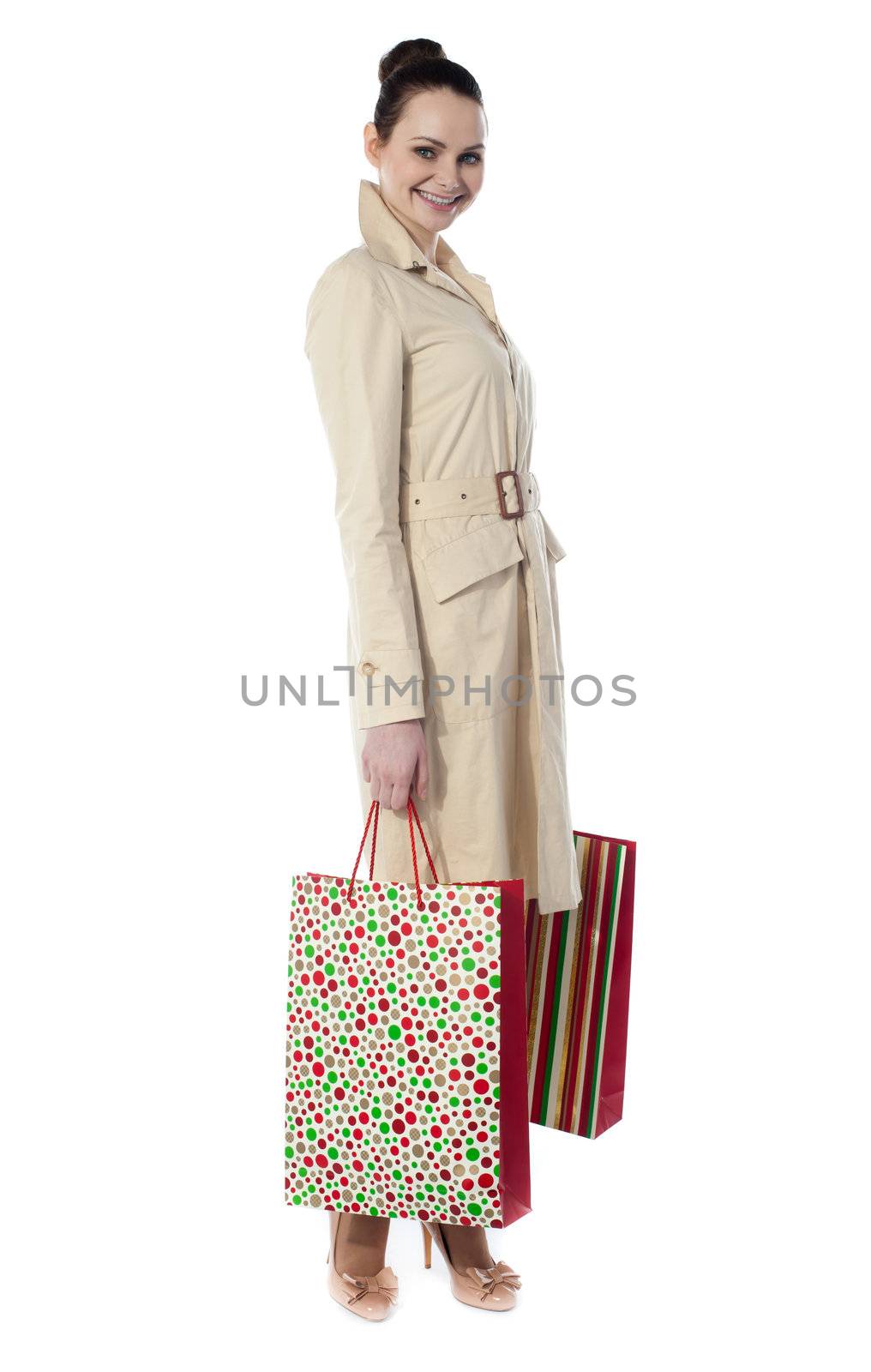 Beautiful happy shopping woman holding shopping bags isolated on white