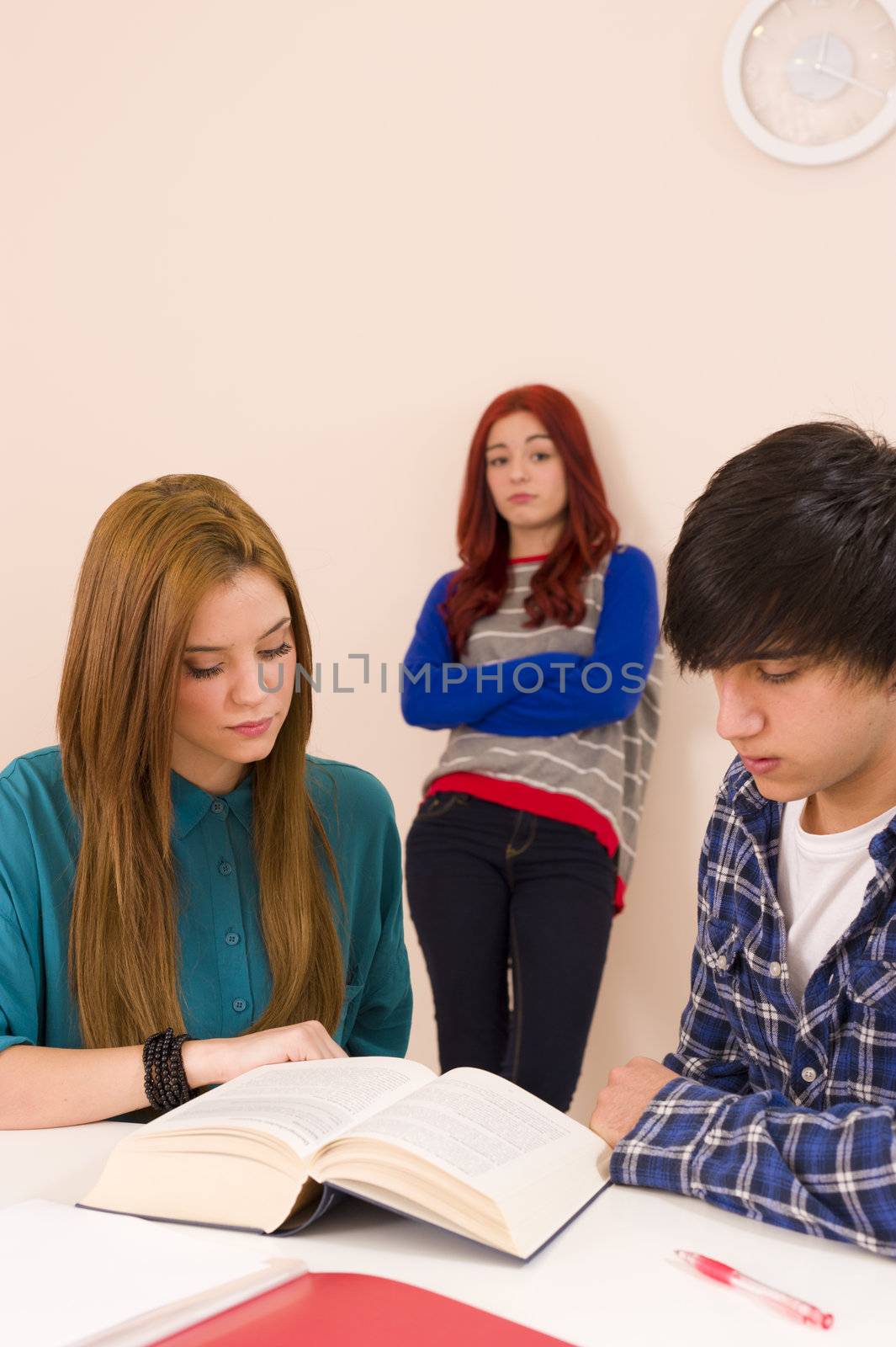 Leaning against the classroom wall and feeling jealous