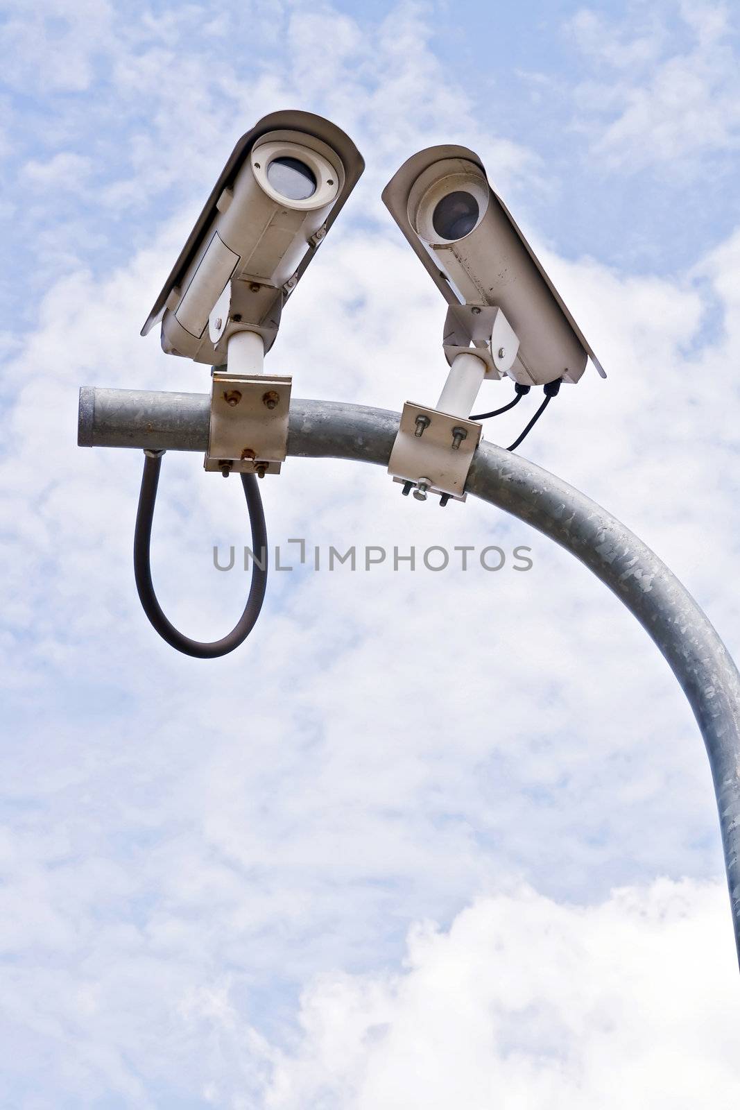 Surveillance Security Camera or CCTV on blue sky