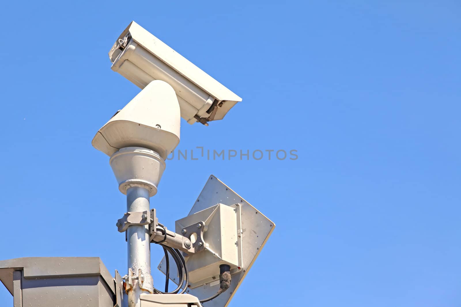closeup of isolated Surveillance Security Camera or CCTV on blue sky