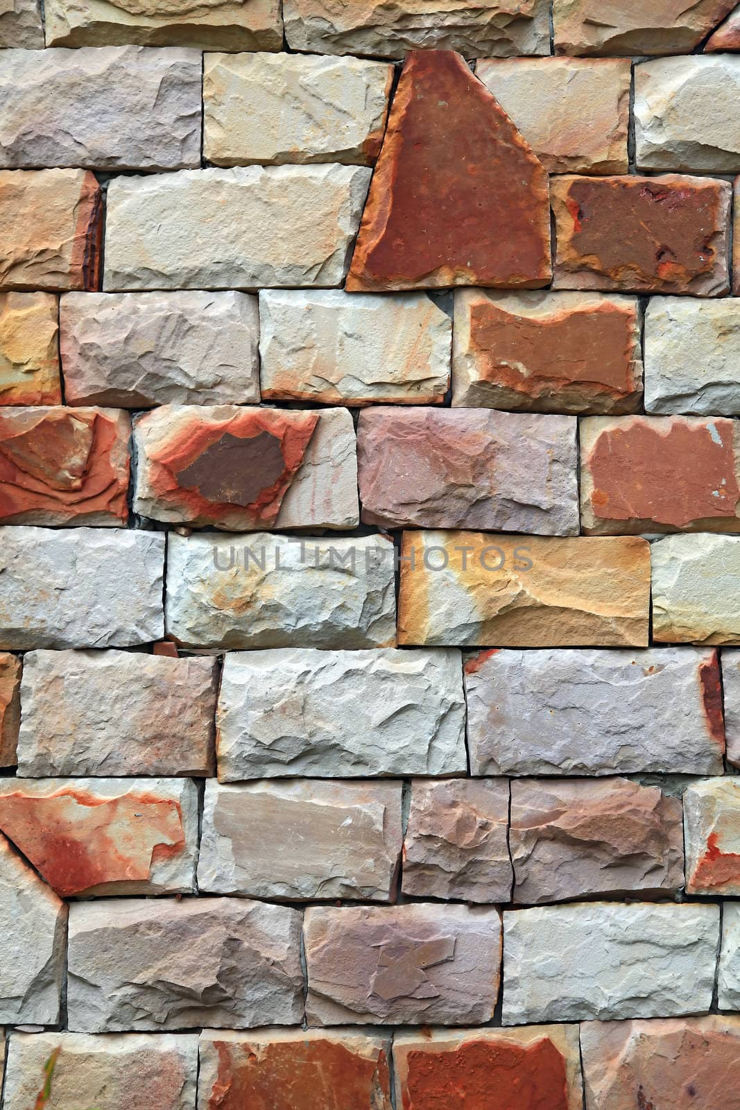 modern irregular shapes of red stone brick wall background, vertical
