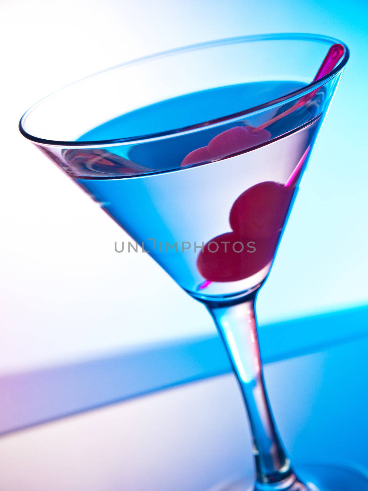 Glass of martini cocktail with cherries