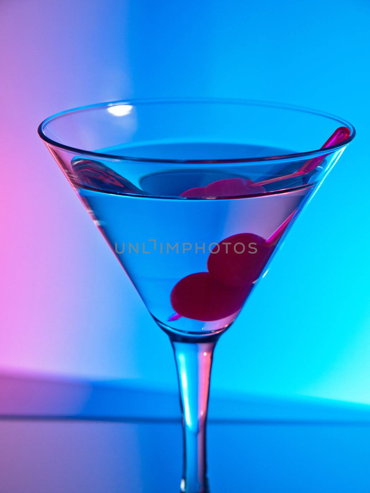 Glass of martini cocktail with cherries