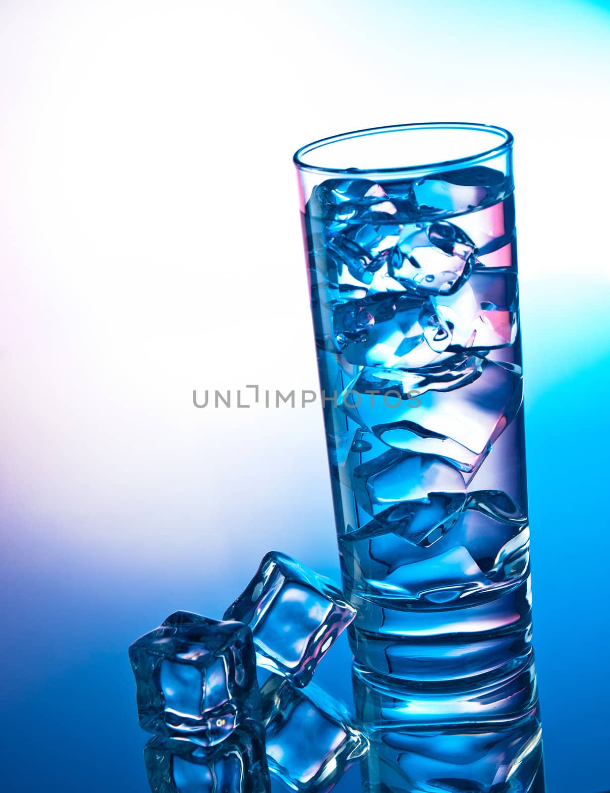 Glass of clear cocktail filled with ice cubes