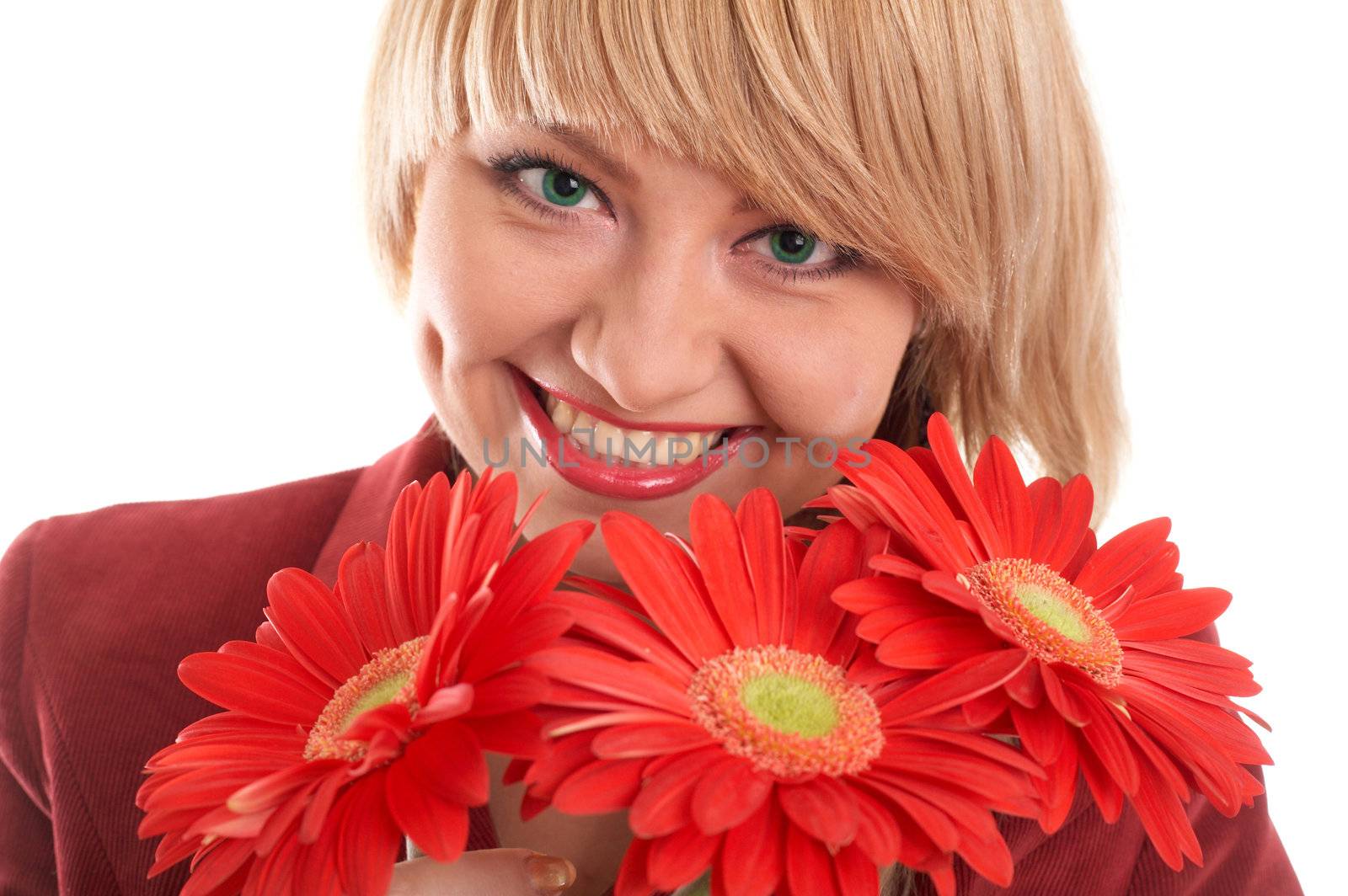 A smiling green-eyed girl with red flowers