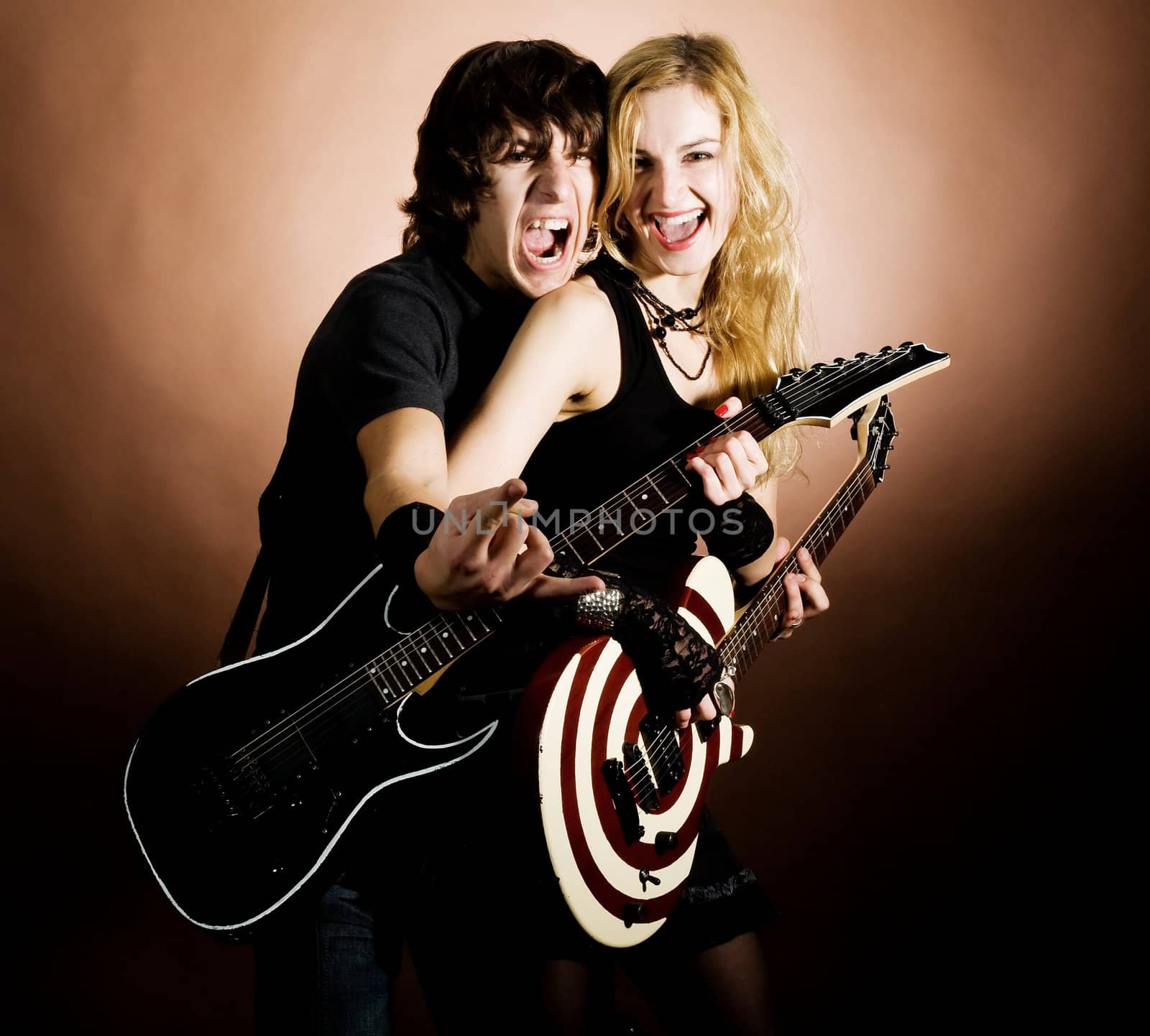 An image of a girl and a boy with guitars