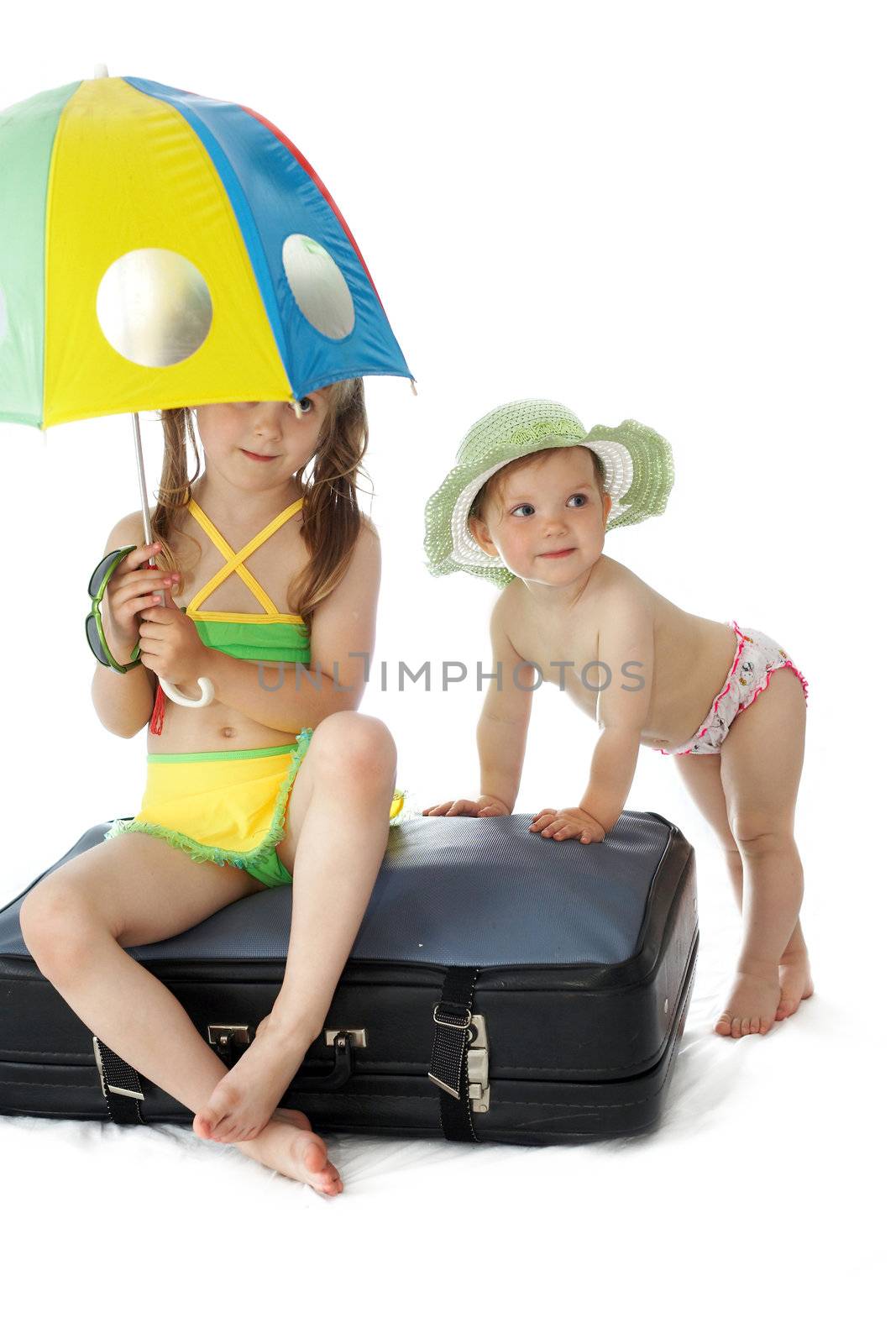 An image of two girls on a valise